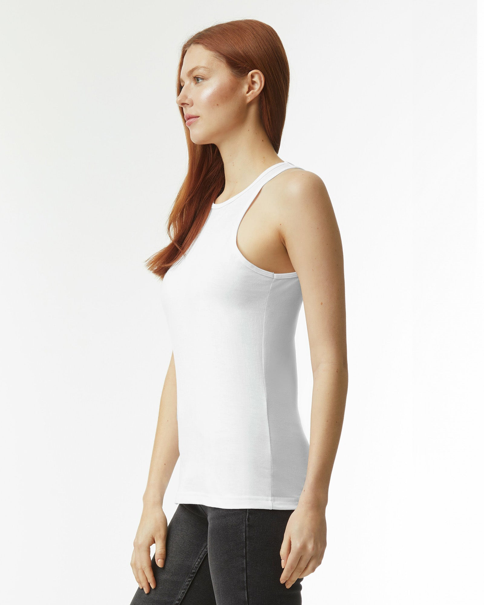 Female model wearing white CVC Women's Racerneck Tank Top (side pose) -white