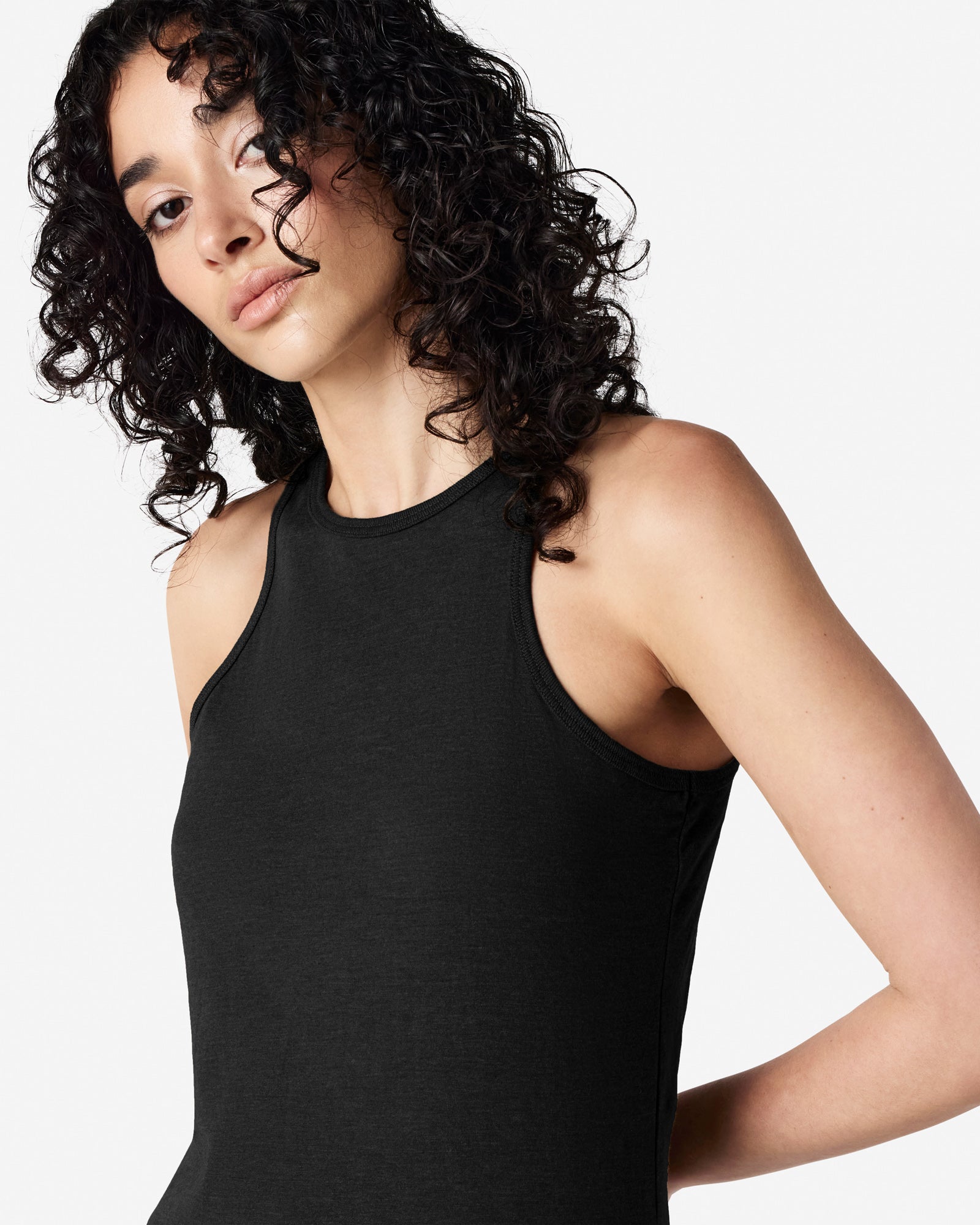 Close-up of a woman wearing American Apparel Racerneck tank top, highlighting the sleek neckline and fitted silhouette - black
