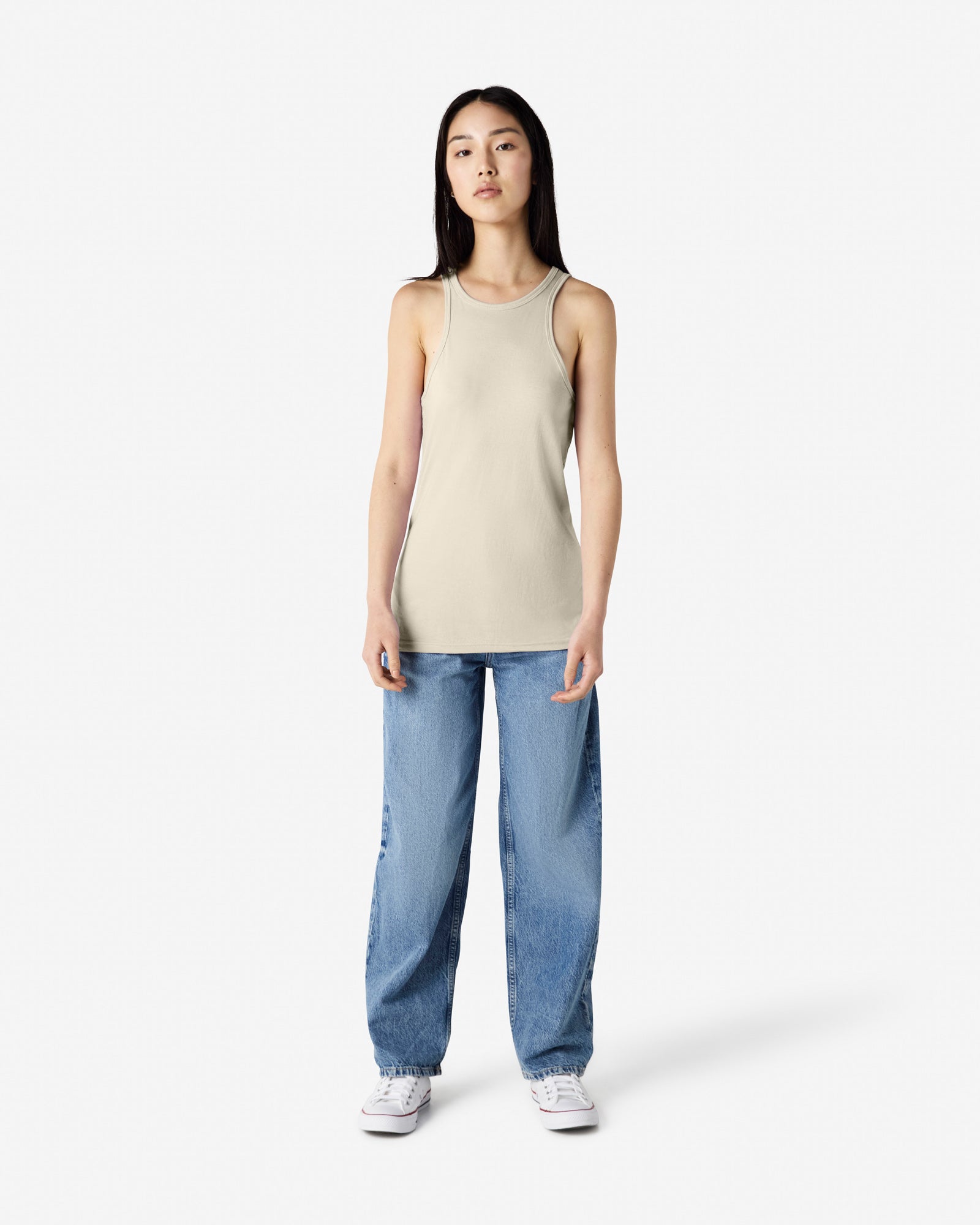 Woman dressed in a American Apparel Racerneck tank top and light-wash cargo jeans, styled casually with sneakers against a white background - heather bone