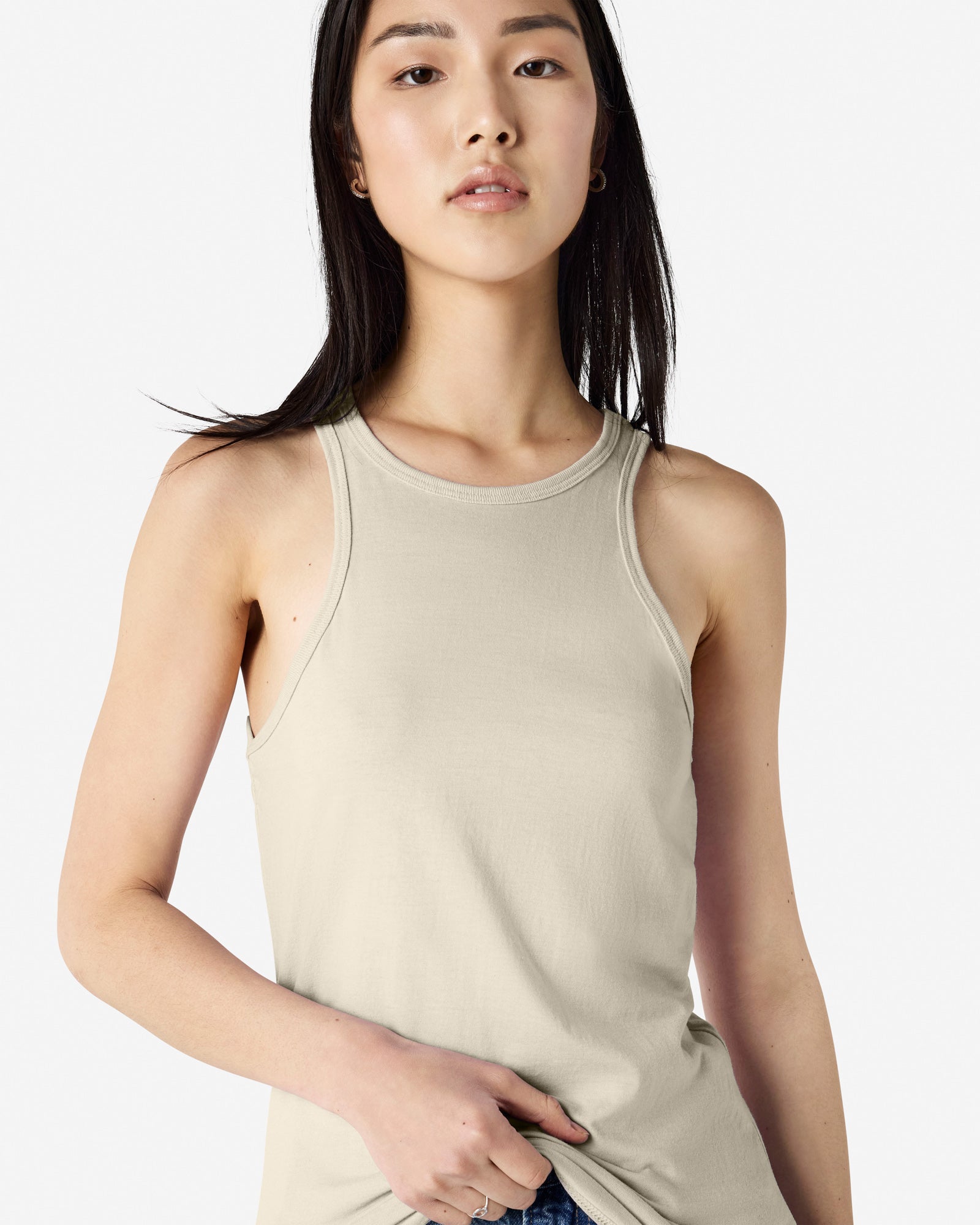 Close-up of a woman wearing a American Apparel Racerneck tank top, highlighting the sleek neckline and fitted silhouette - heather bone