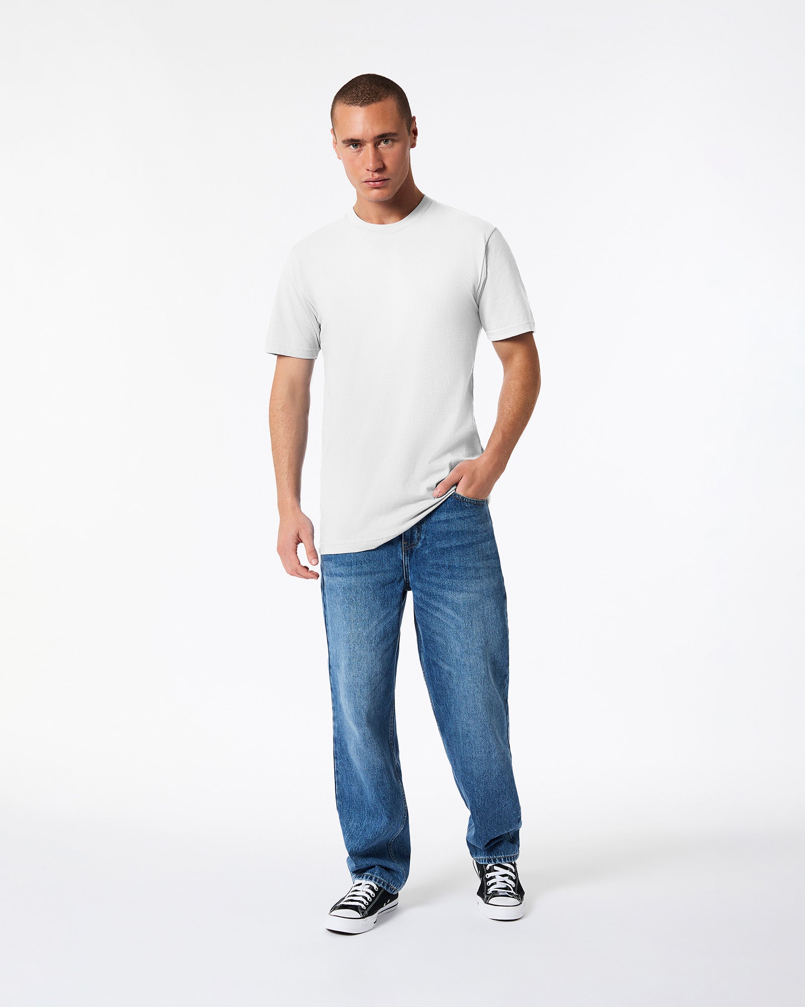 male model wearing white Fine Jersey Unisex Crew Neck Tee (hand in pocket front pose) -white