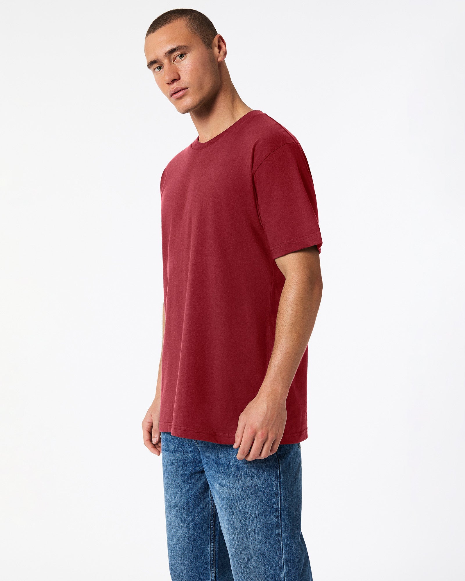 Male mode wearing cranberry colour American Apparel Fine jersey Unisex Short Sleeve Crew Neck Tee (side pose) -cranberry