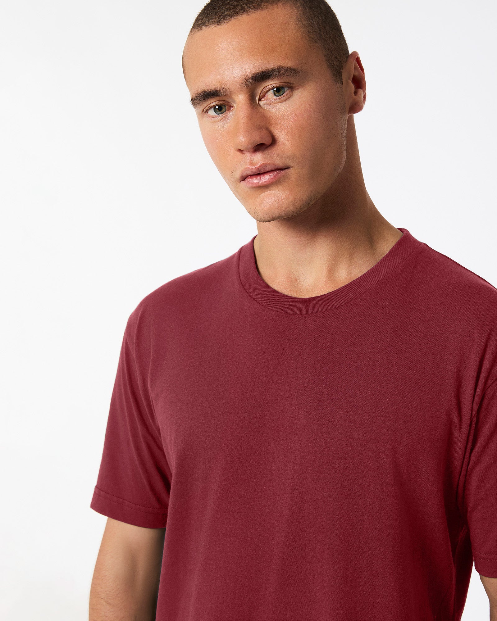 Male mode wearing cranberry colour American Apparel Fine jersey Unisex Short Sleeve Crew Neck Tee (Half Front pose) -cranberry