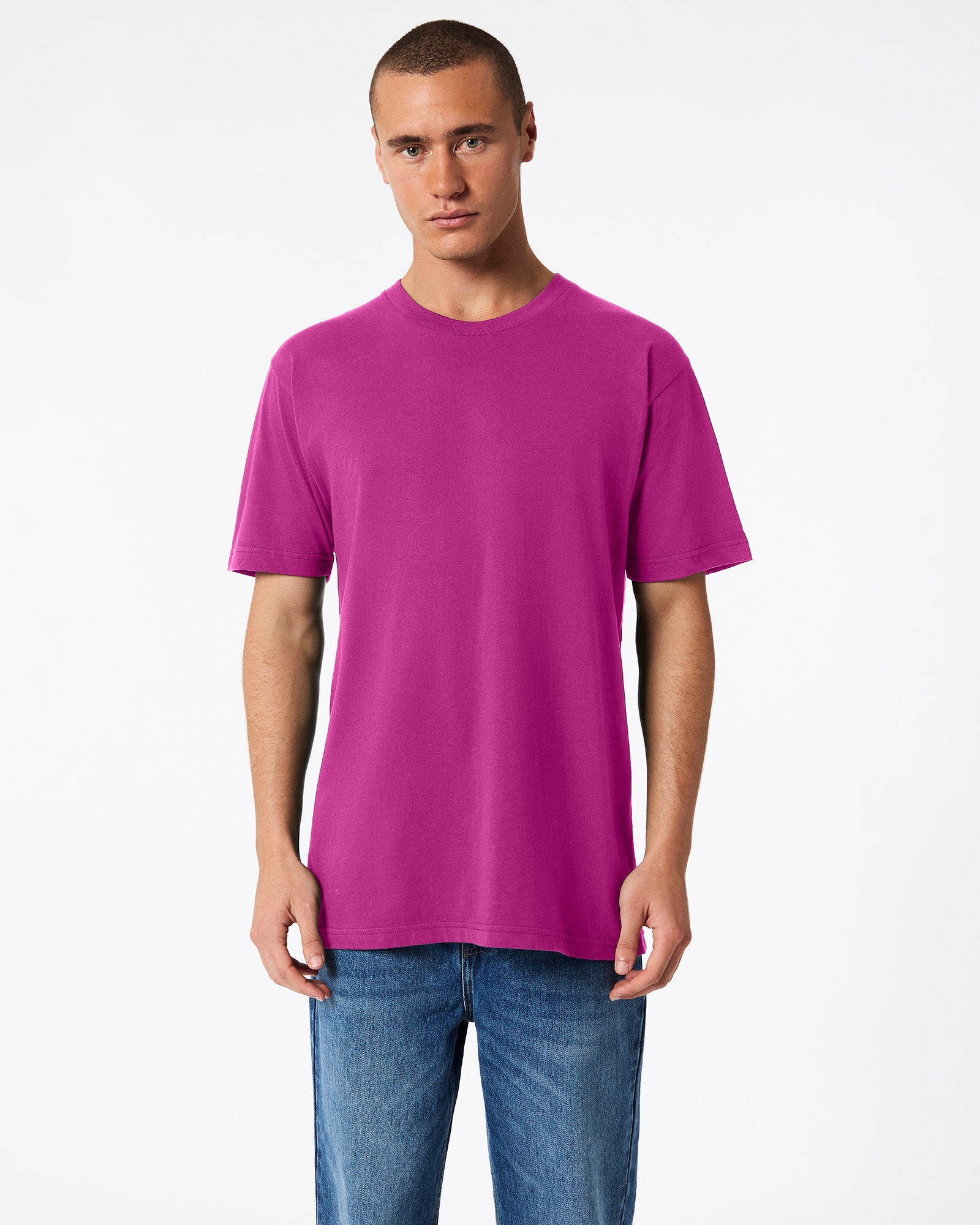 Male model wearing American Apparel Powder Super pink Colour Fine Jersey Unisex Short Sleeve Crew Neck Tee (front pose) -super pink