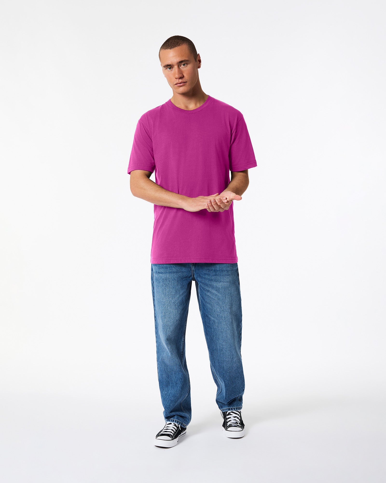Male model wearing American Apparel Powder Super pink Colour Fine Jersey Unisex Short Sleeve Crew Neck Tee (front pose) -super pink
