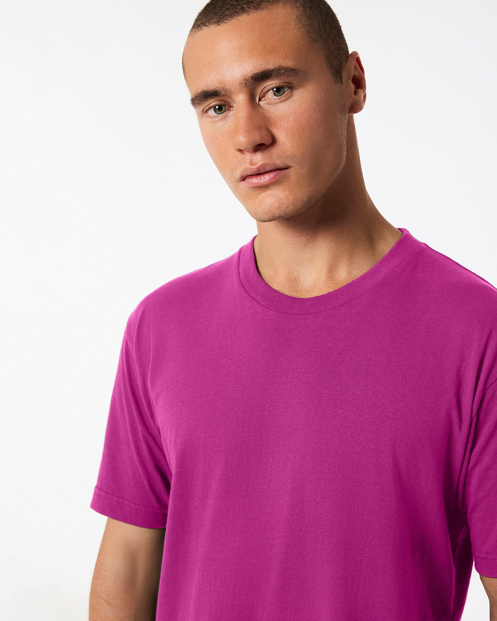 Male model wearing American Apparel Powder Super pink Colour Fine Jersey Unisex Short Sleeve Crew Neck Tee (half front pose) -super pink