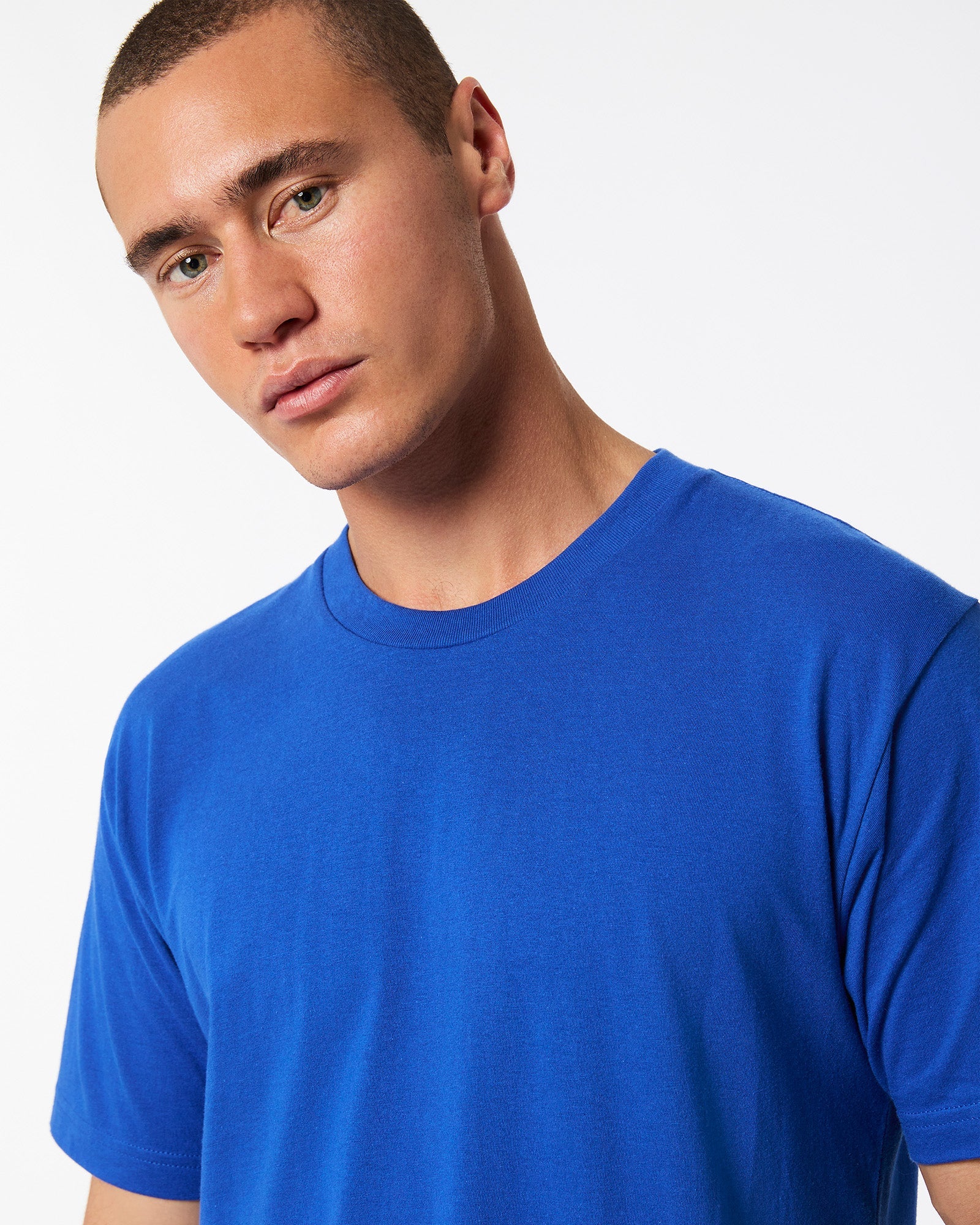 Male model wearing American Apparel Powder Royal Blue Colour Fine Jersey Unisex Short Sleeve Crew Neck Tee (half front pose) -royal blue