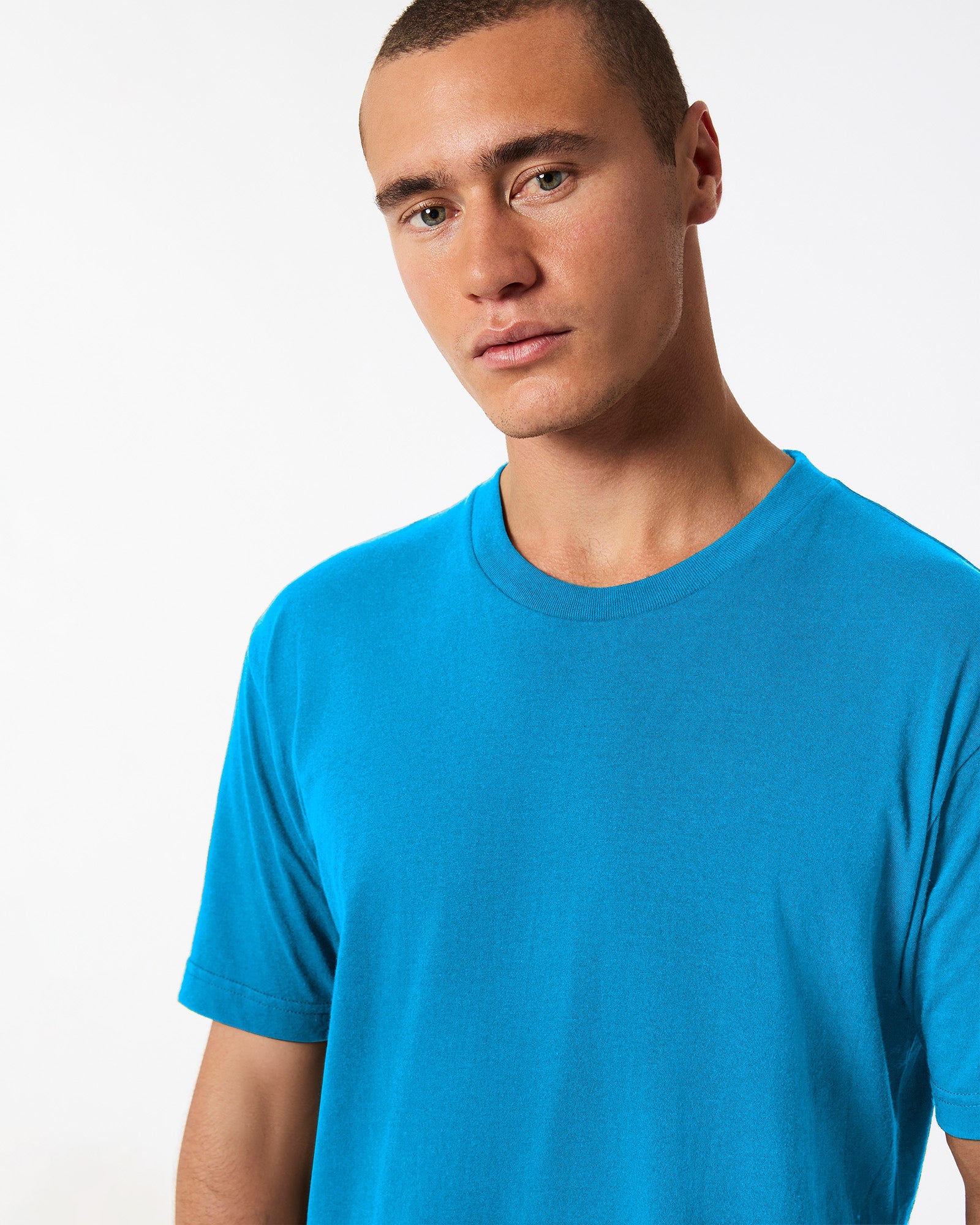 Male model wearing American Apparel Powder teal Colour Fine Jersey Unisex Short Sleeve Crew Neck Tee (half front pose) -teal