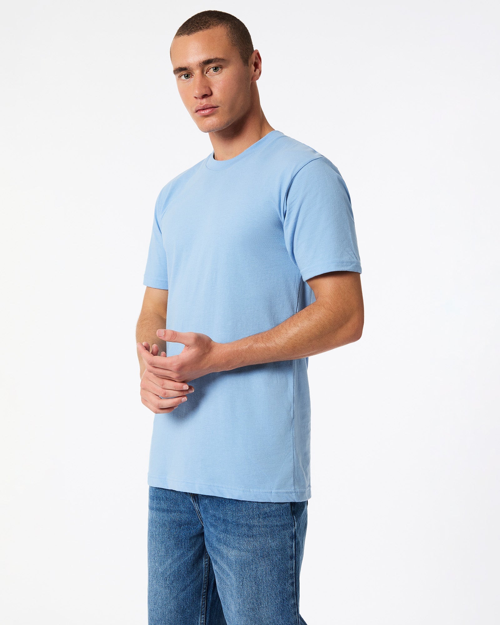 Male model wearing American Apparel Powder Blue Colour Fine Jersey Unisex Short Sleeve Crew Neck Tee (side pose) -powder blue