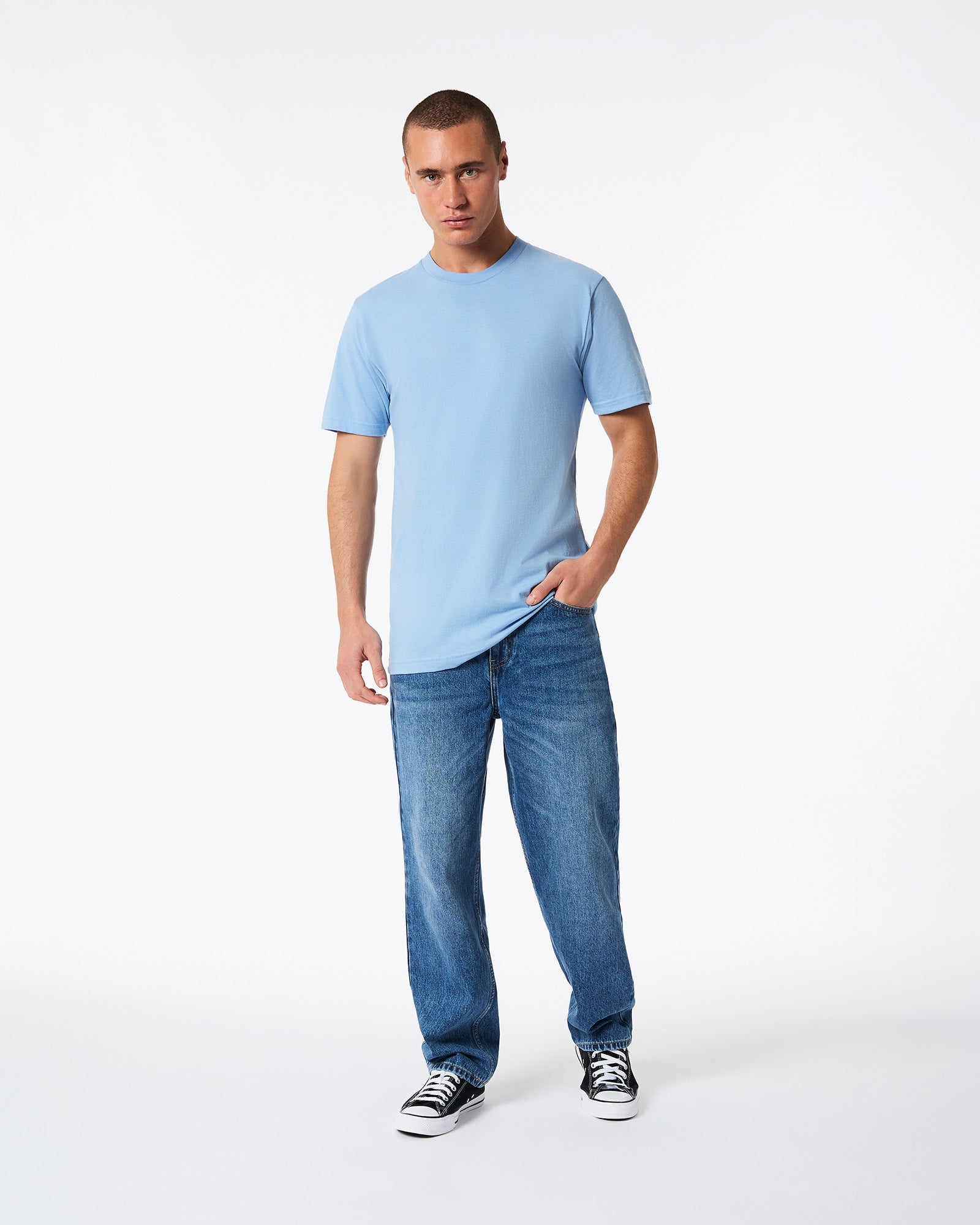 Male model wearing American Apparel Powder Blue Colour Fine Jersey Unisex Short Sleeve Crew Neck Tee (hand in pocket pose) -powder blue