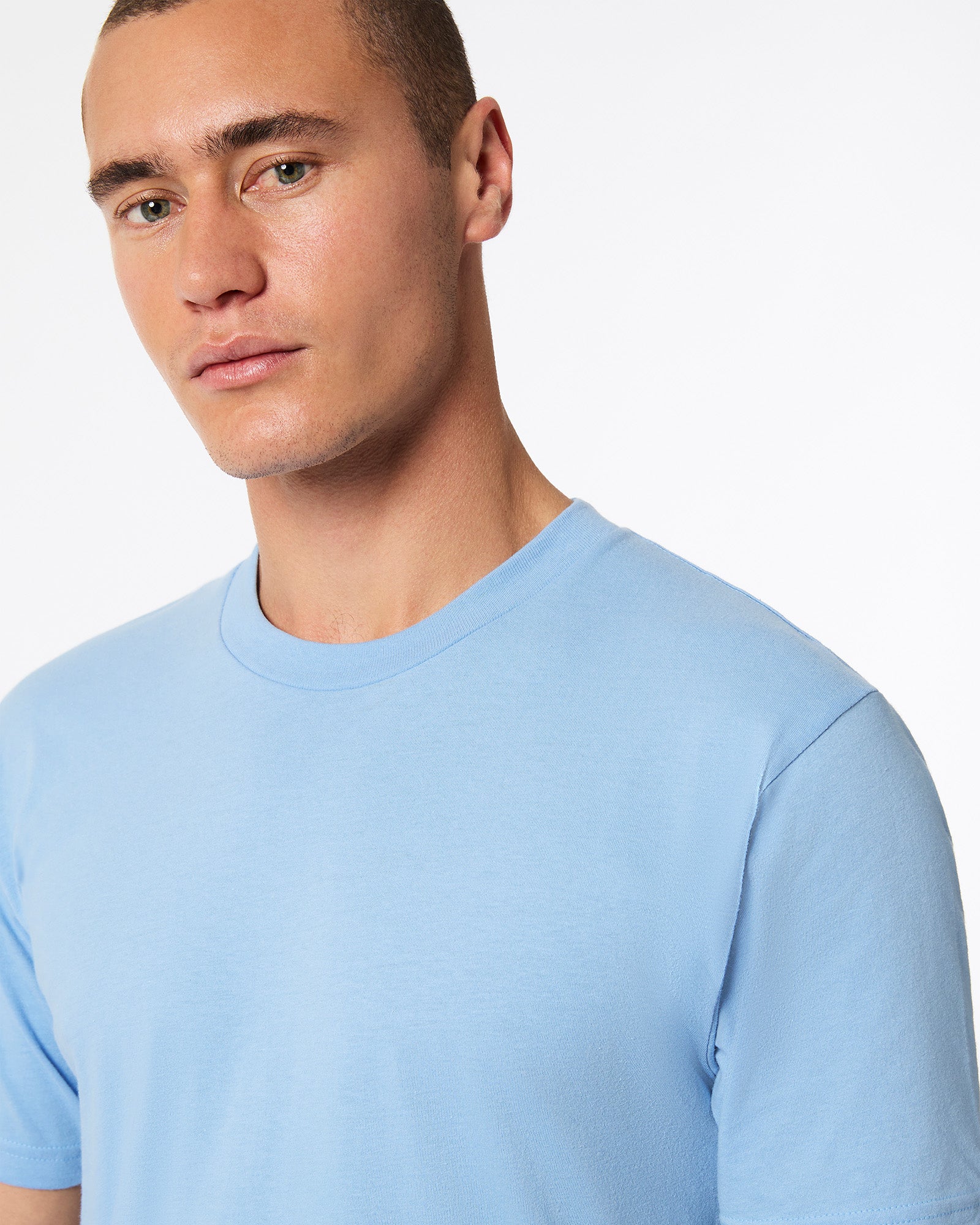 Male model wearing American Apparel Powder Blue Colour Fine Jersey Unisex Short Sleeve Crew Neck Tee (half front pose) -powder blue