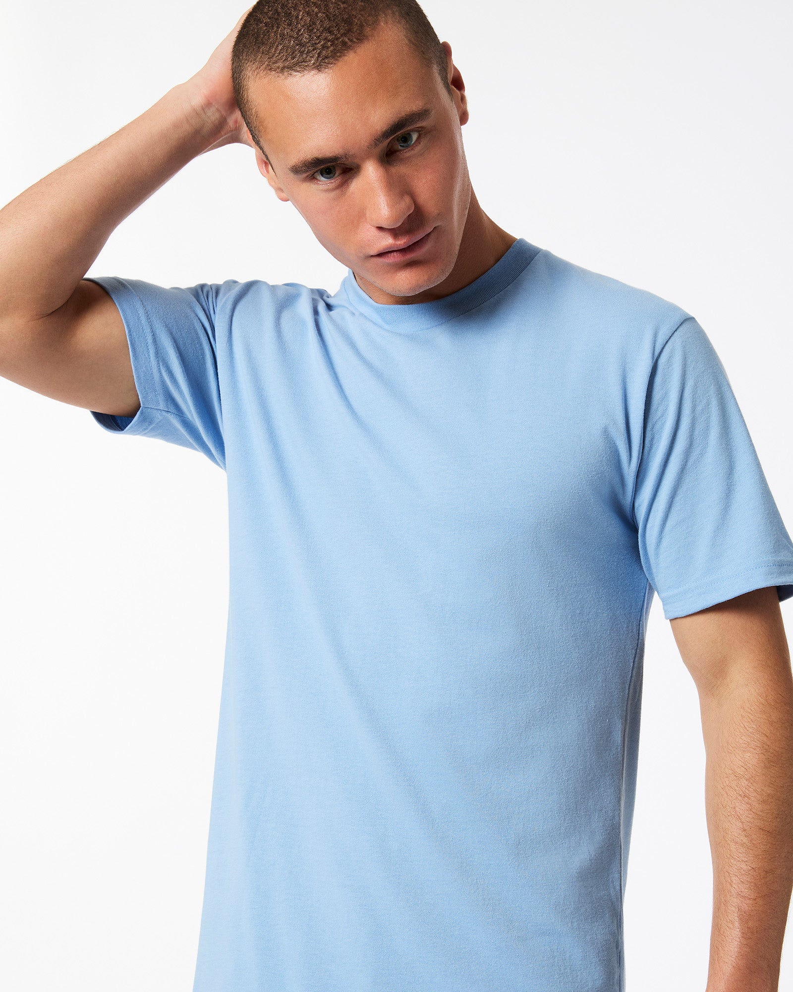 Male model wearing American Apparel Powder Blue Colour Fine Jersey Unisex Short Sleeve Crew Neck Tee (hand behind head pose) -powder blue