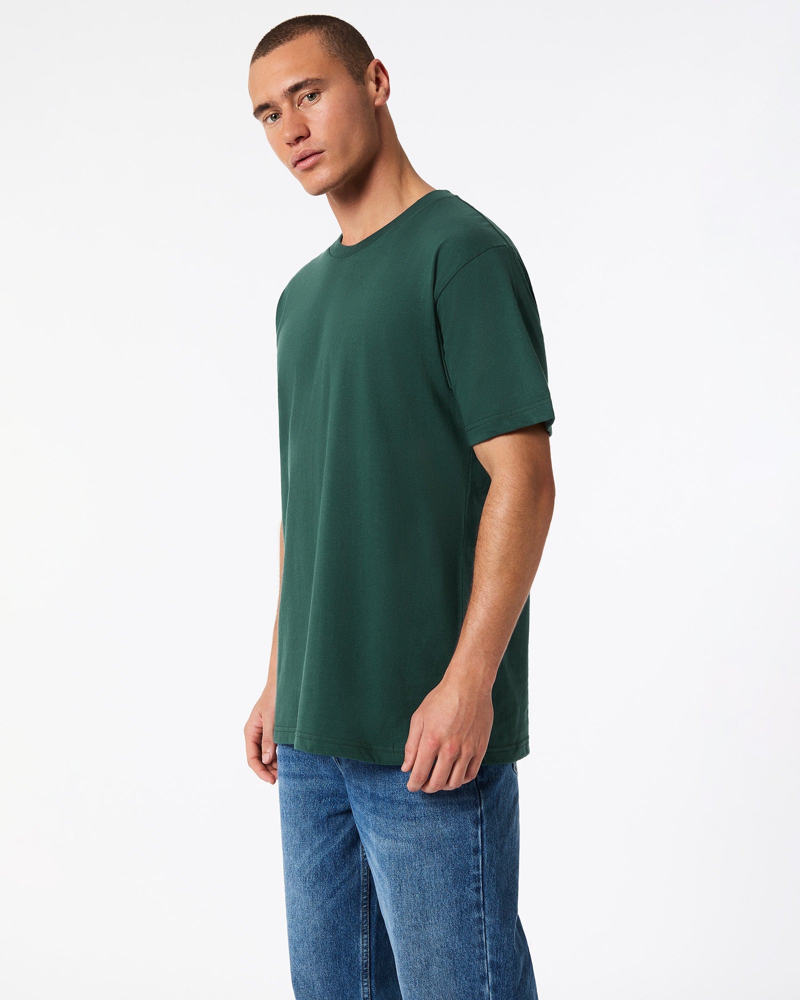 Male mode wearing forest colour American Apparel Fine jersey Unisex Short Sleeve Crew Neck Tee (side pose) -forest