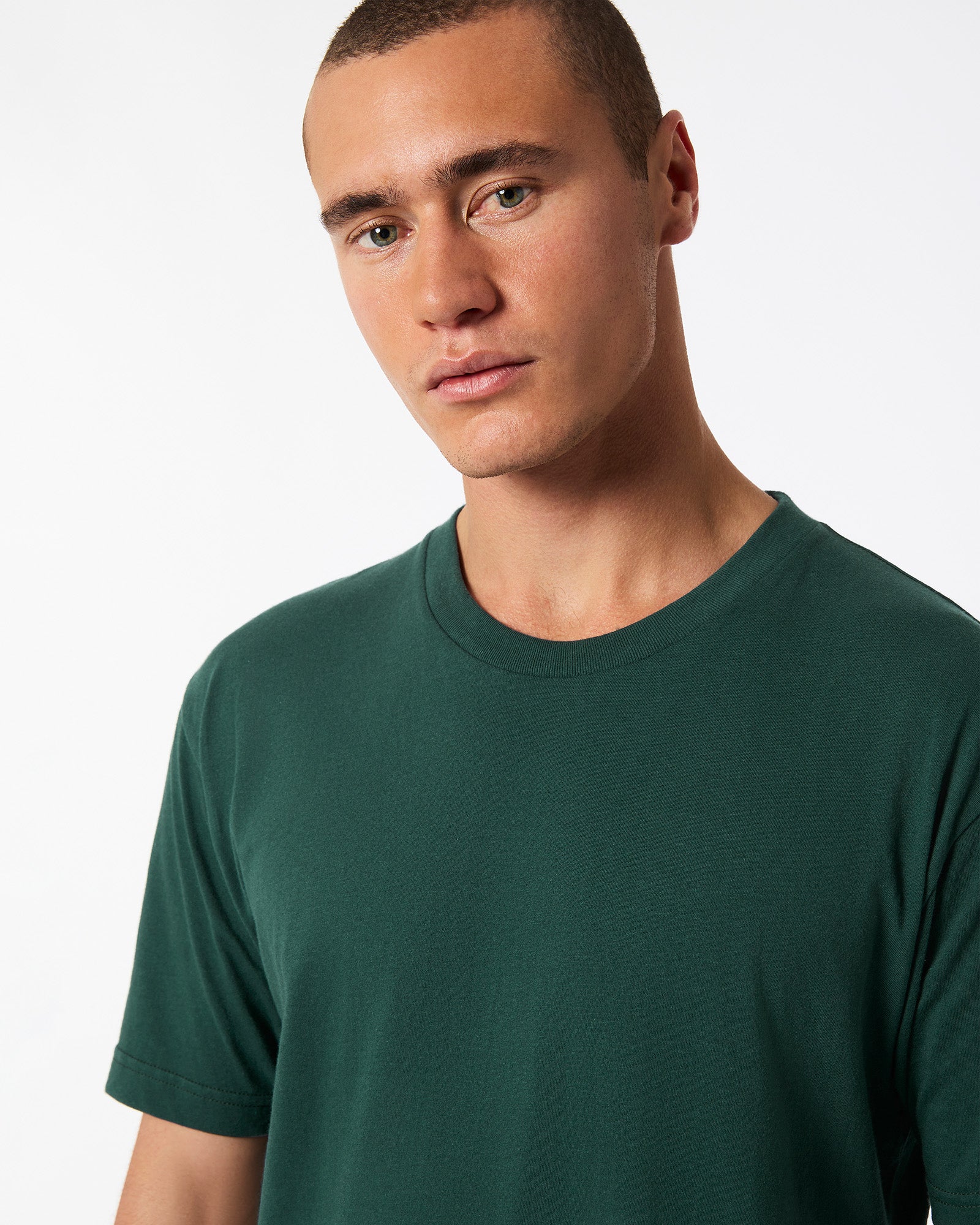 Male mode wearing forest colour American Apparel Fine jersey Unisex Short Sleeve Crew Neck Tee (Half Front pose) -forest