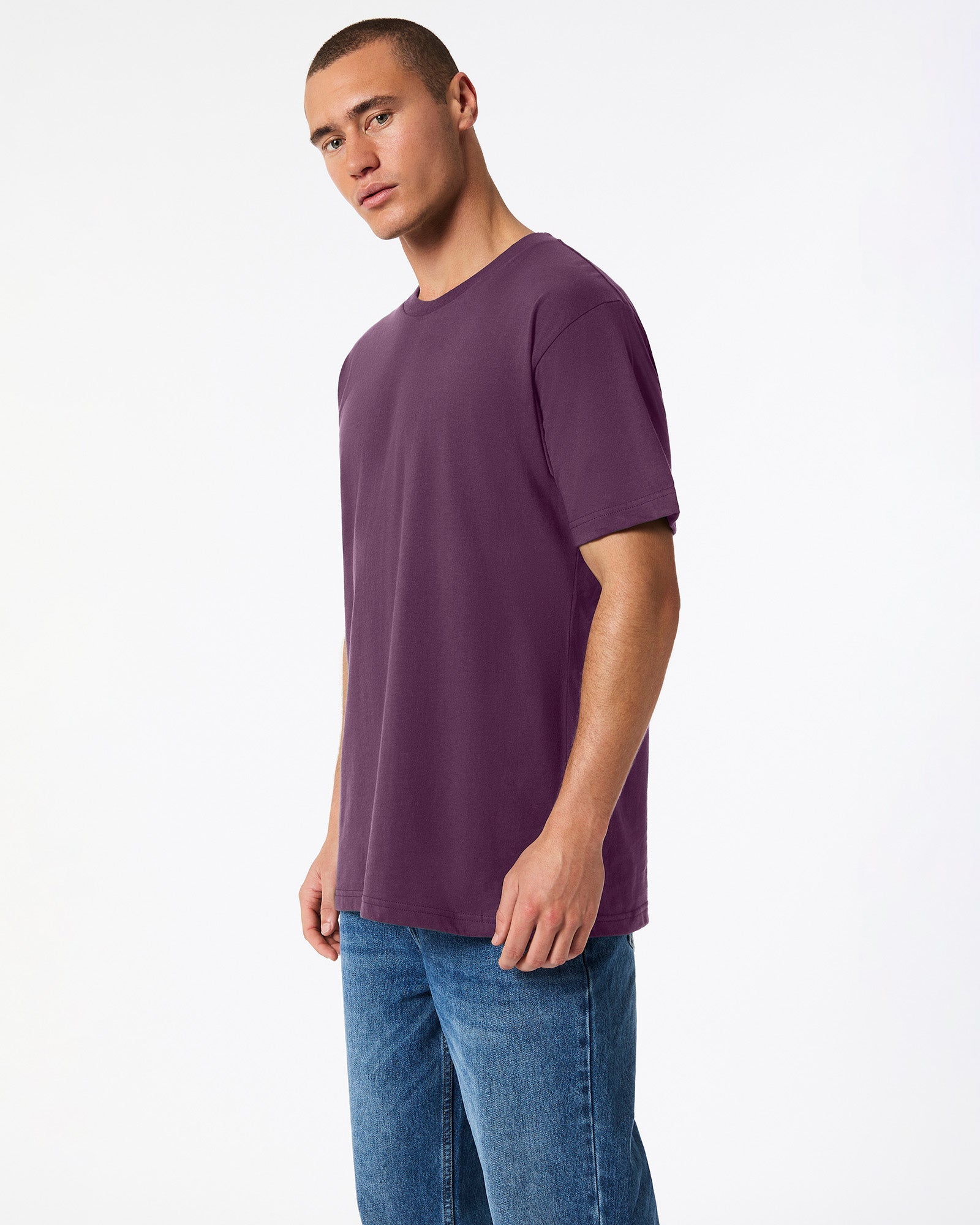 Male mode wearing eggplant colour American Apparel Fine jersey Unisex Short Sleeve Crew Neck Tee (side pose) -eggplant