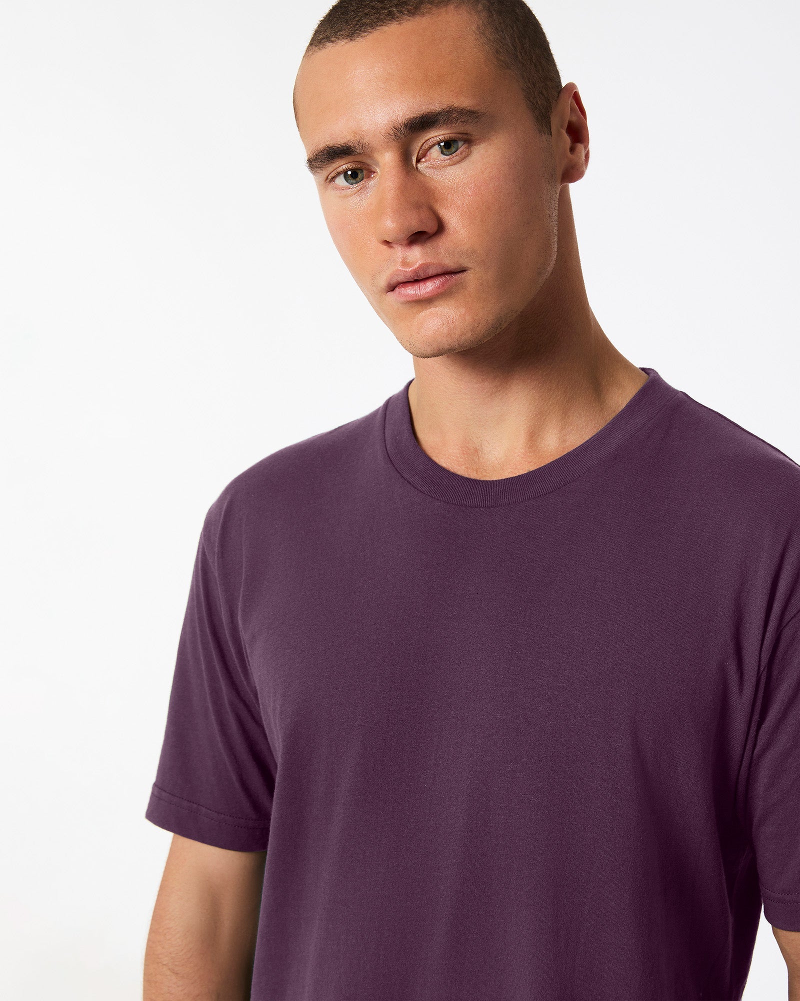Male mode wearing eggplant colour American Apparel Fine jersey Unisex Short Sleeve Crew Neck Tee (half Front pose) -eggplant