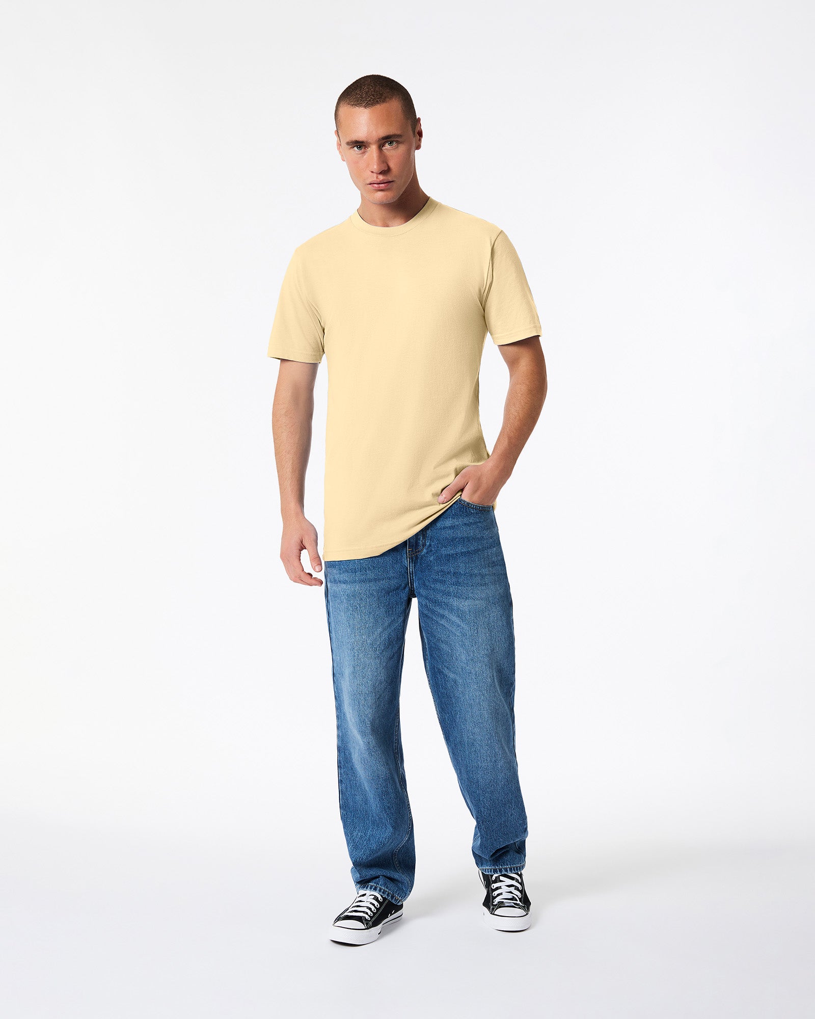 Male mode wearing cream colour American Apparel Fine jersey Unisex Short Sleeve Crew Neck Tee (hand in pocket pose) -cream