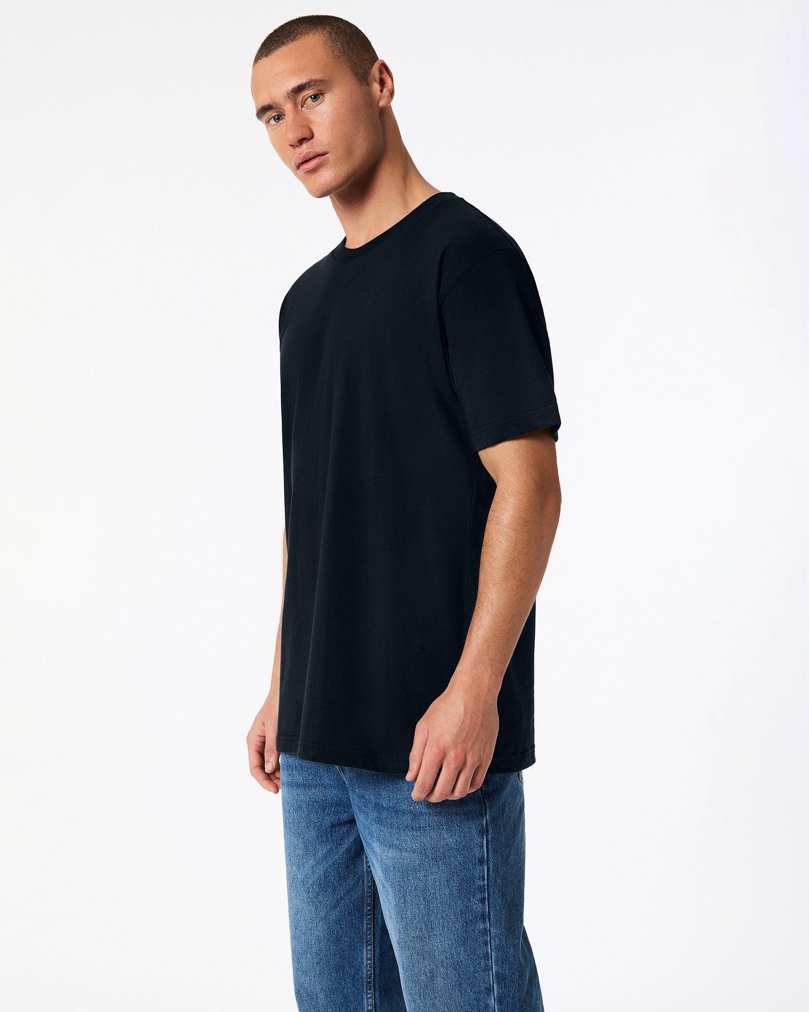 Fine Jersey Male mode wearing black colour American Apparel Unisex Short Sleeve Crew Neck Tee (side pose) -black