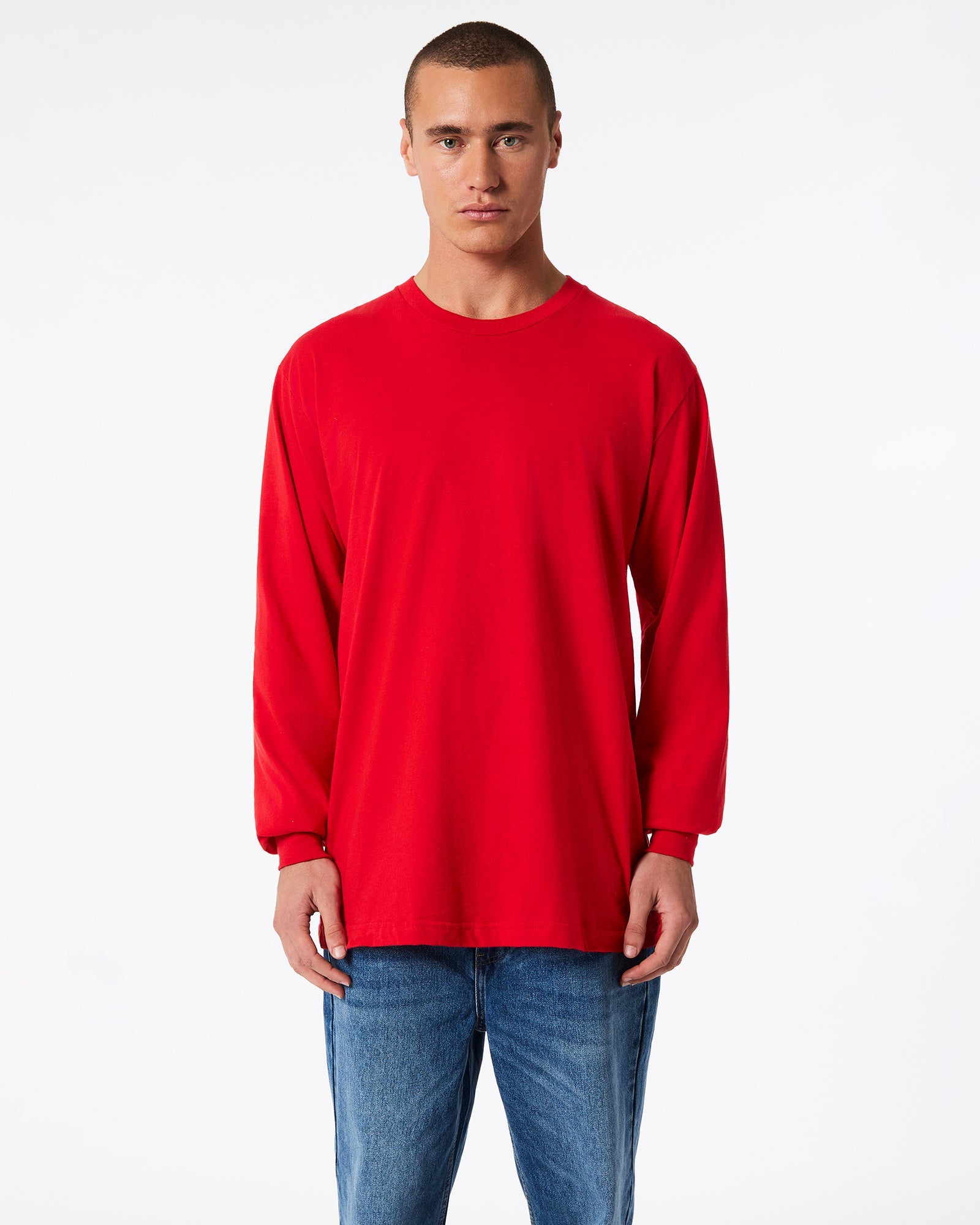male model wearing American Apparel Red Colour Fine Jersey Unisex Long Sleeve Crew Neck Tee (Front pose) -red