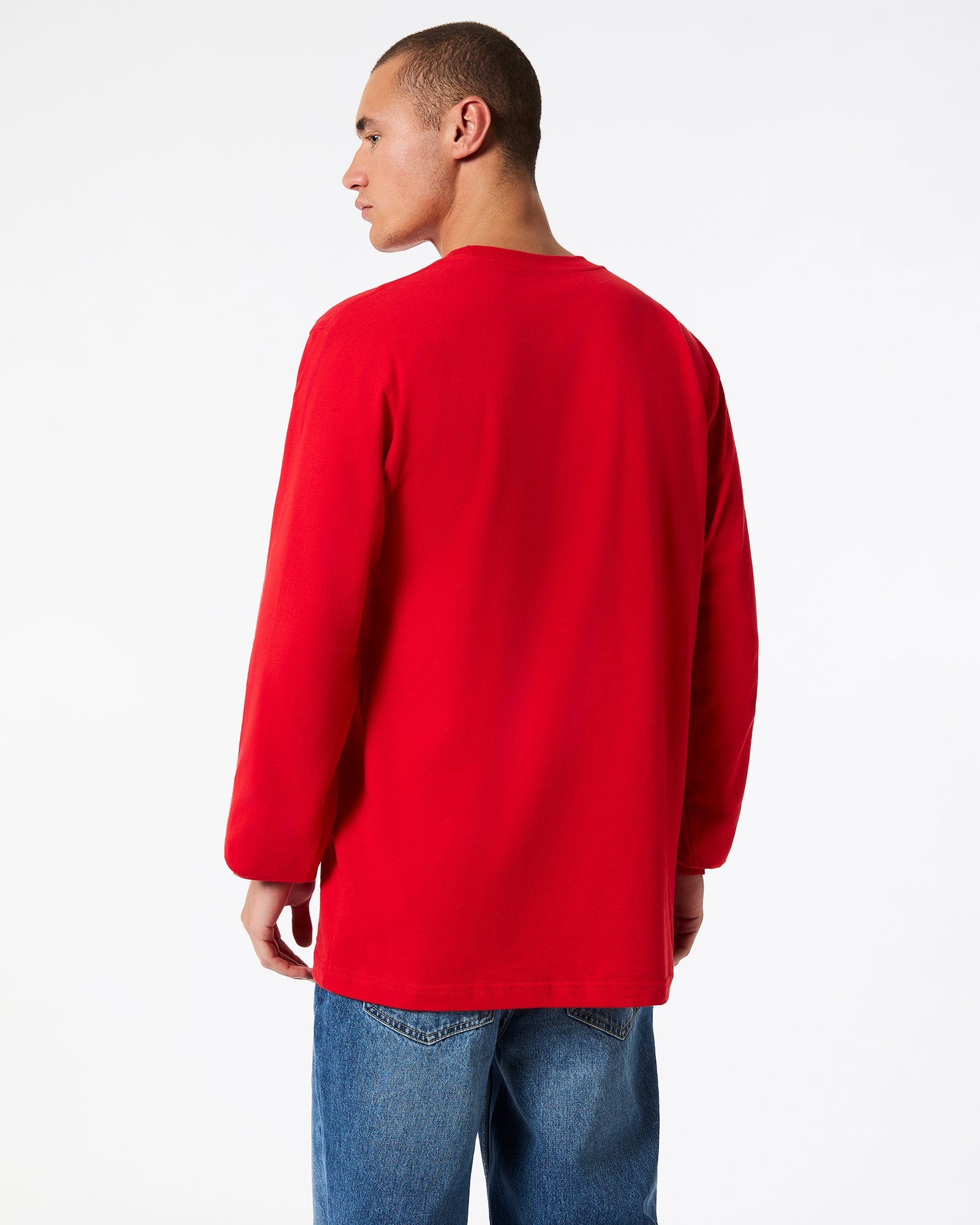 male model wearing American Apparel Red Colour Fine Jersey Unisex Long Sleeve Crew Neck Tee (Back pose) -red