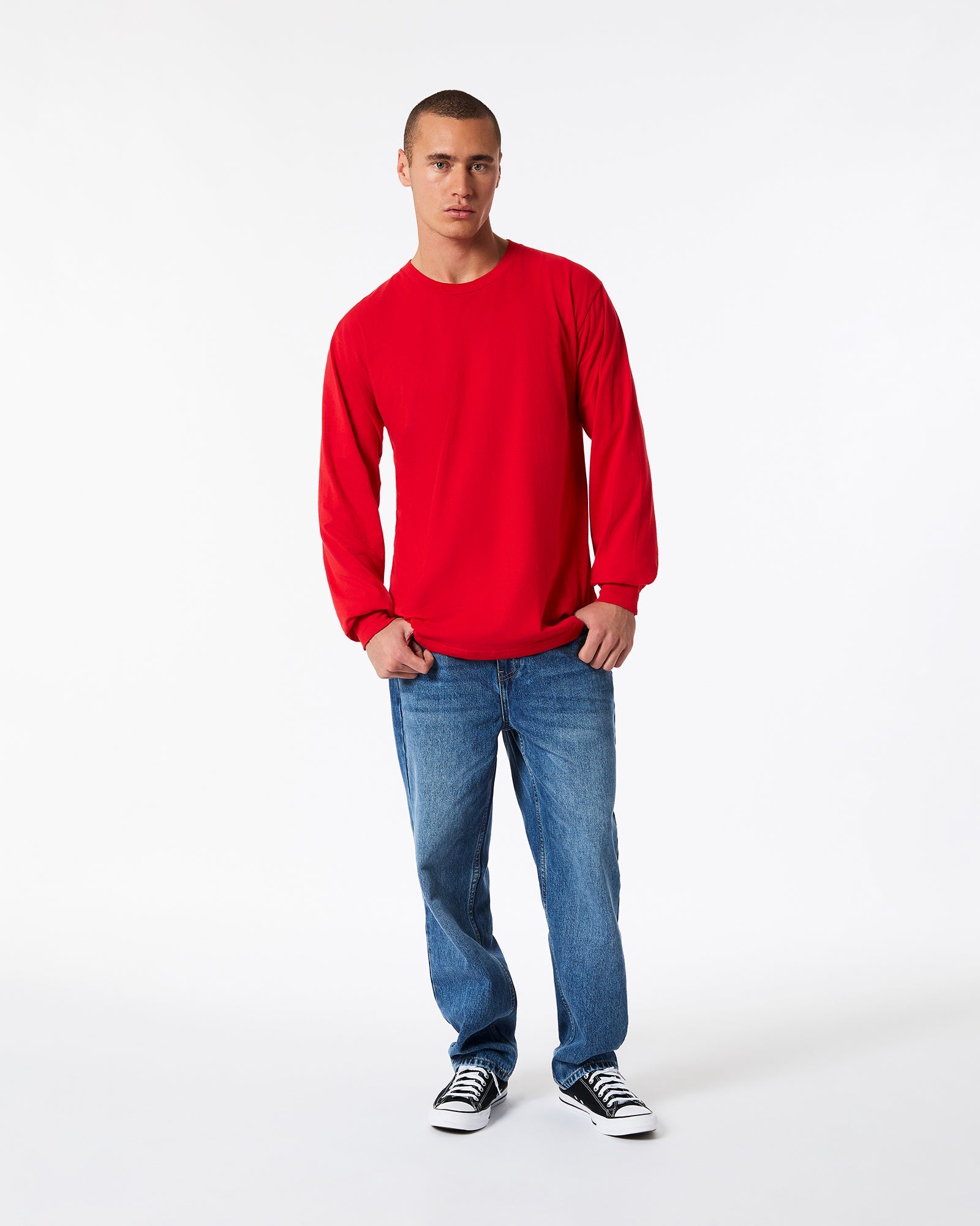 male model wearing American Apparel Red Colour Fine Jersey Unisex Long Sleeve Crew Neck Tee (Front pose) -red