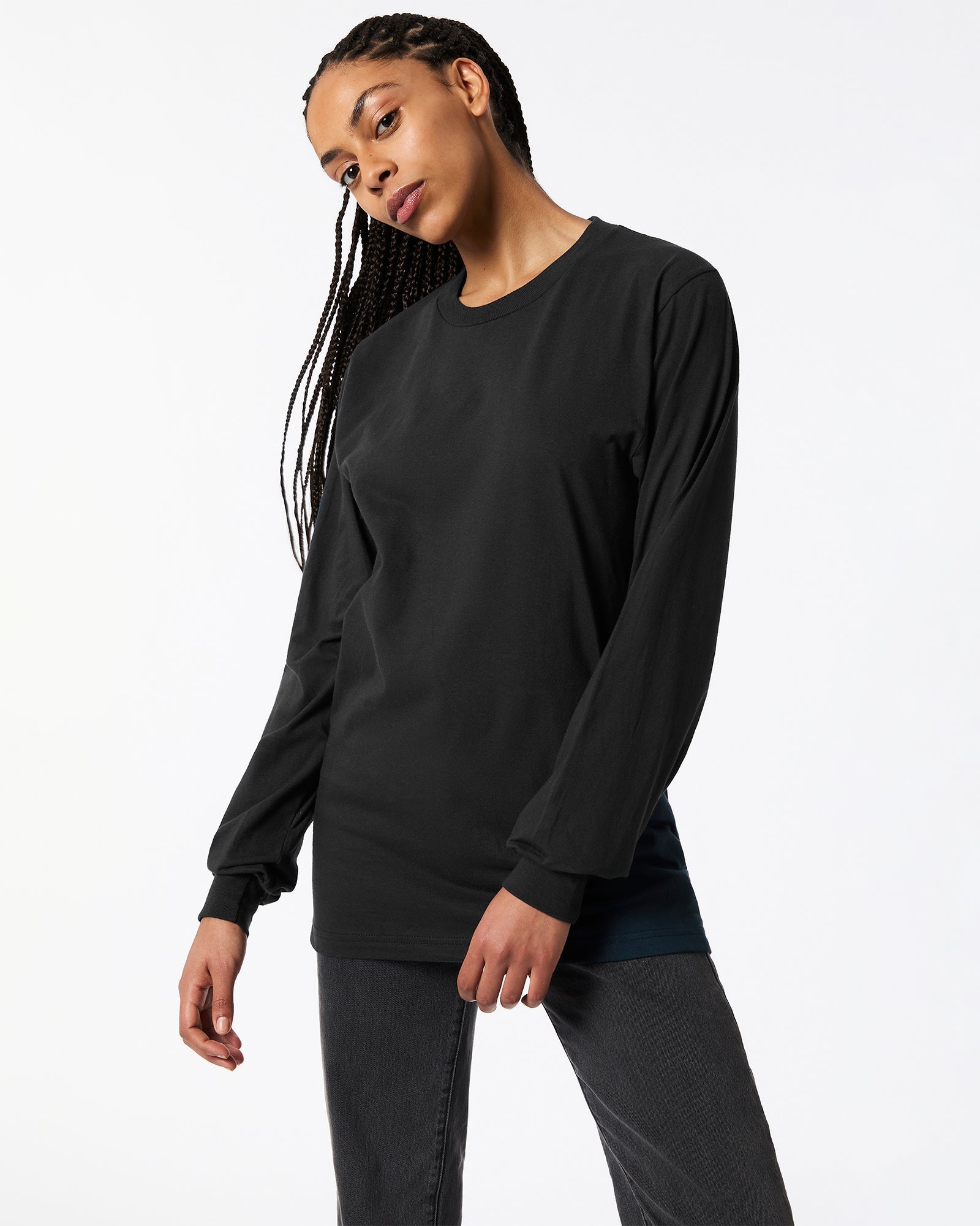 Female model posing while wearing Black Colour Fine Jersey Unisex Long Sleeve Crew Neck Tee (Front pose) -black