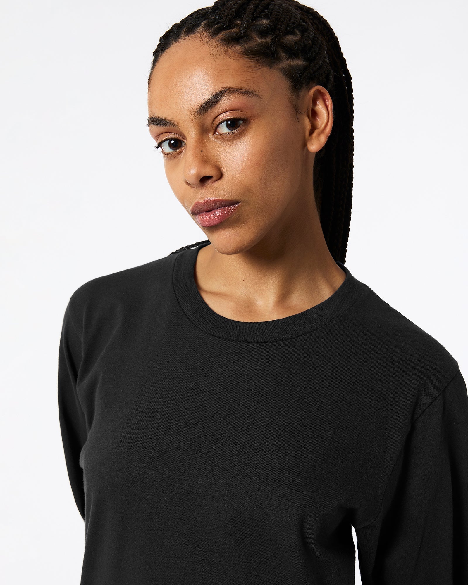 Female model wearing Black Colour Fine Jersey Unisex Long Sleeve Crew Neck Tee (half Front pose) -black