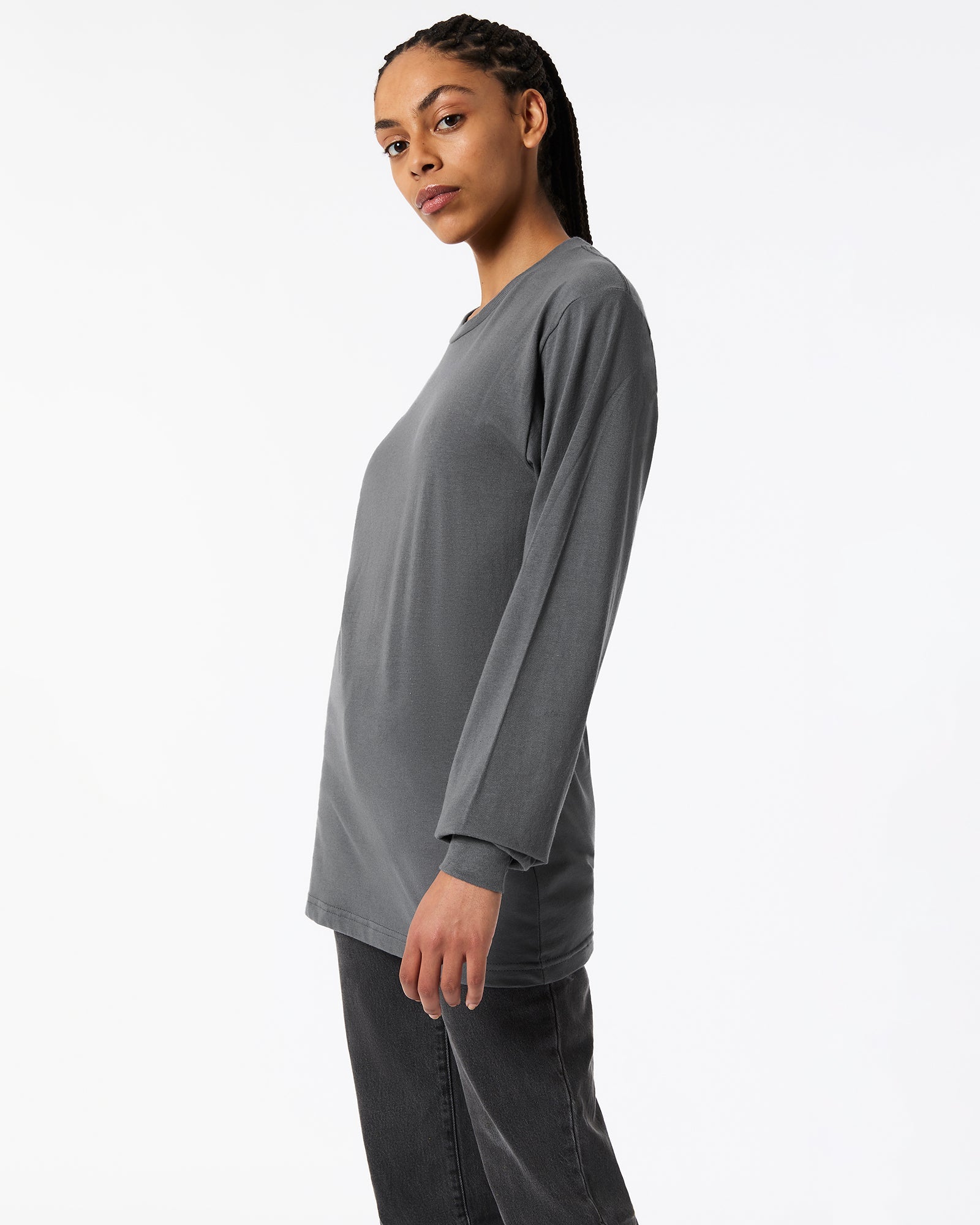 Female model wearing Asphalt Colour Fine Jersey Unisex Long Sleeve Crew Neck Tee (Side pose) -asphalt