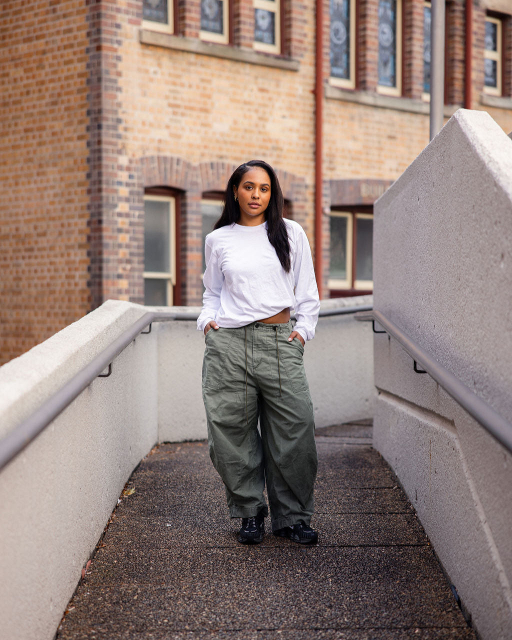 Female model wearing American Apparel Red Colour Fine Jersey Unisex Long Sleeve Crew Neck Tee (Front pose) -white