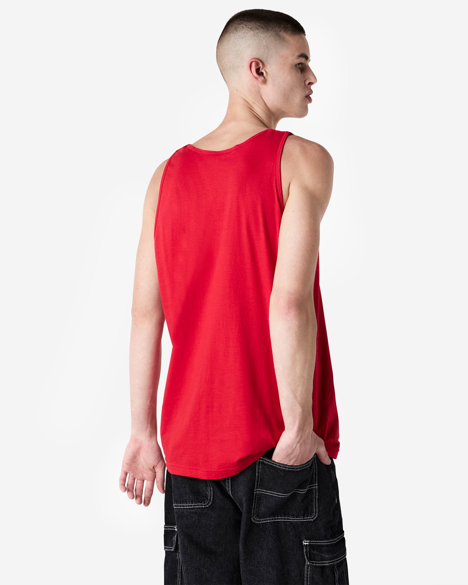 Male model wearing red colour American Apparel Fine Jersey Unisex Tank Top (back pose with hand in pocket) -red