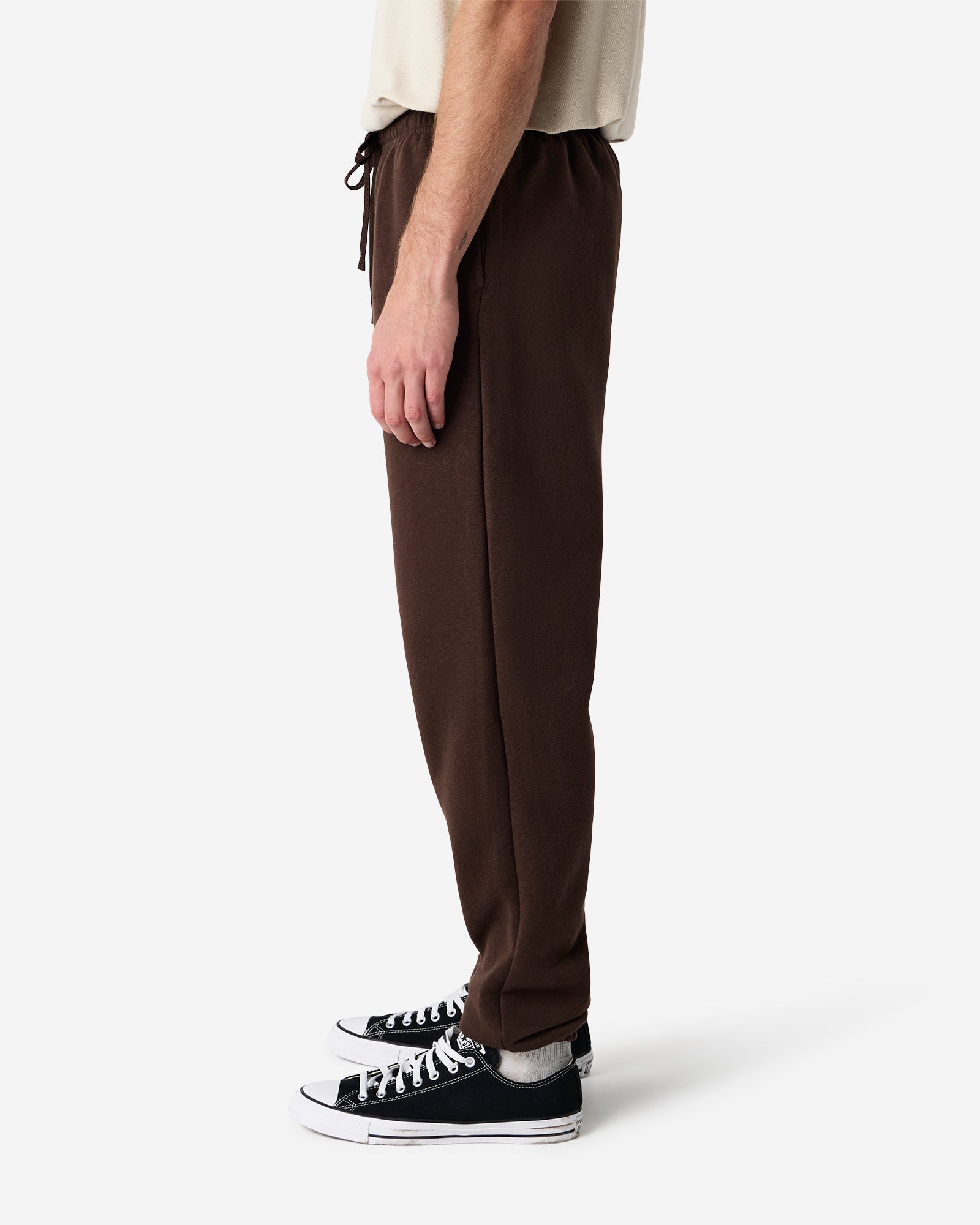 Male model wearing American Apparel Bone Sweatpants (side pose) -brown