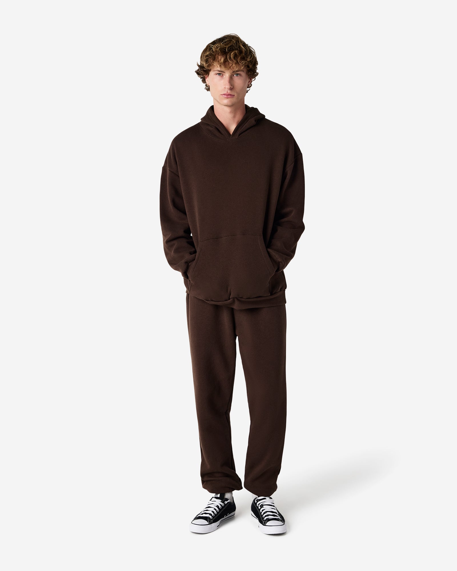 Male model wearing American Apparel Bone Sweatpants (full length pose) -brown