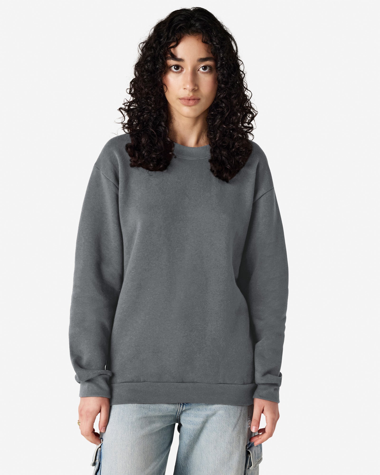 Female model wearing a Reflex Unisex Crewneck Sweatshirt (front pose) -asphalt