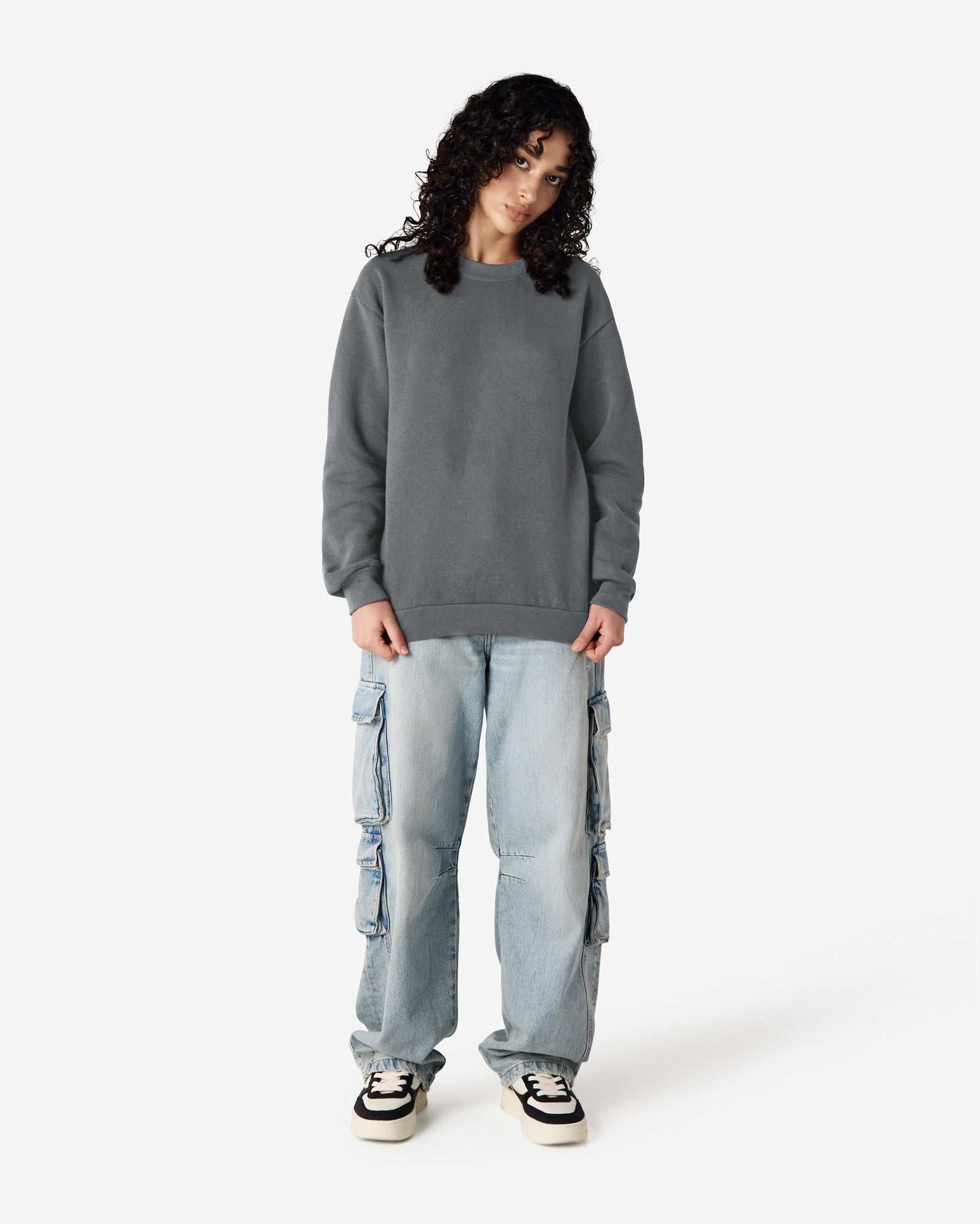 Female model wearing a Reflex Unisex Crewneck Sweatshirt (front pose) -asphalt