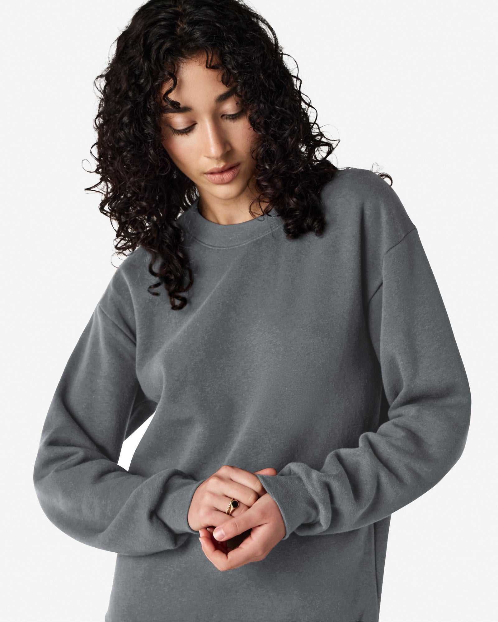 Female model wearing a Reflex Unisex Crewneck Sweatshirt (front pose) -asphalt