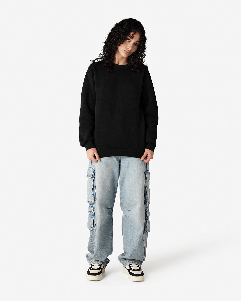 Female model wearing a Reflex Unisex Crewneck Sweatshirt (front pose) -black