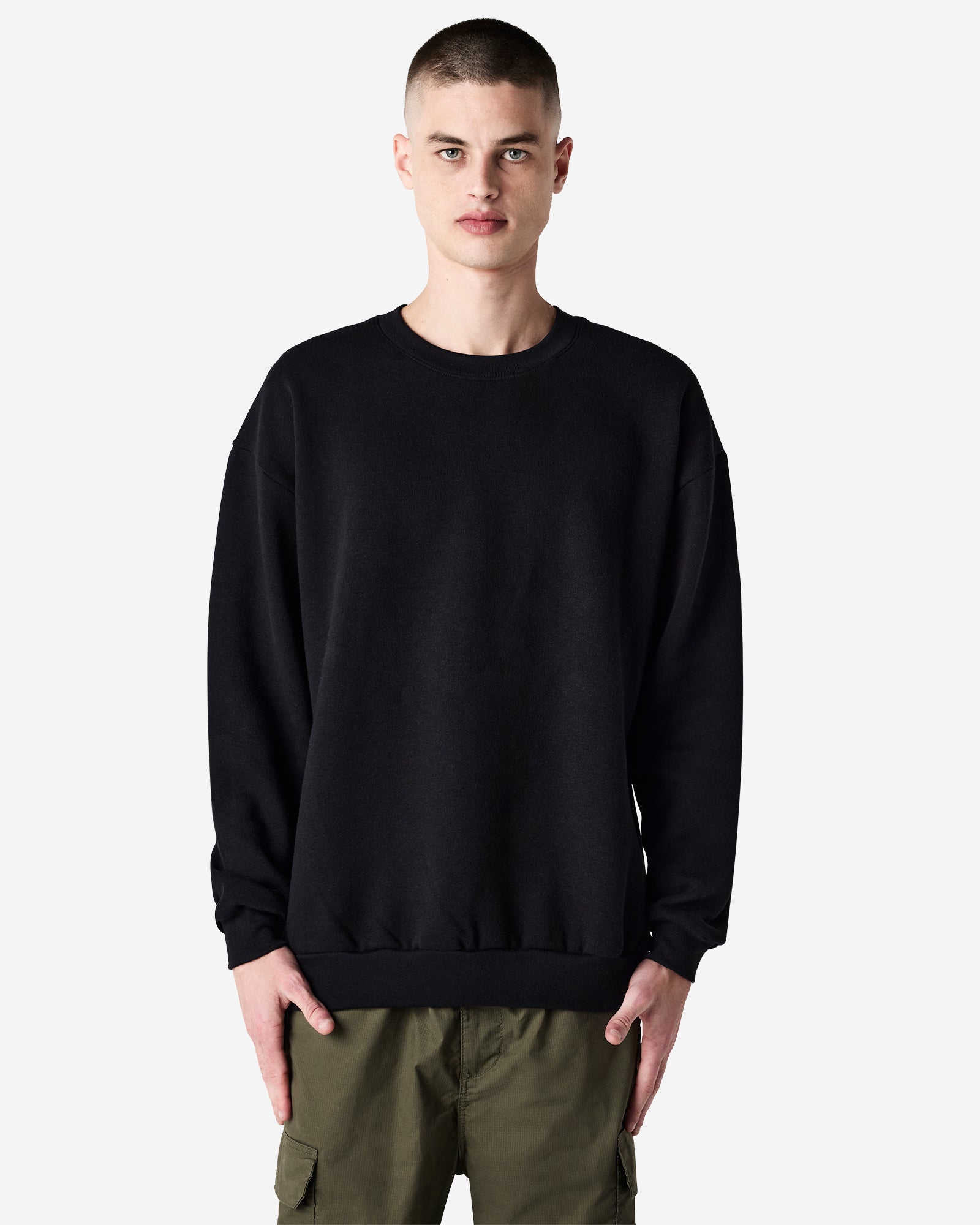 Male model wearing a Reflex Unisex Crewneck Sweatshirt (front pose) -black