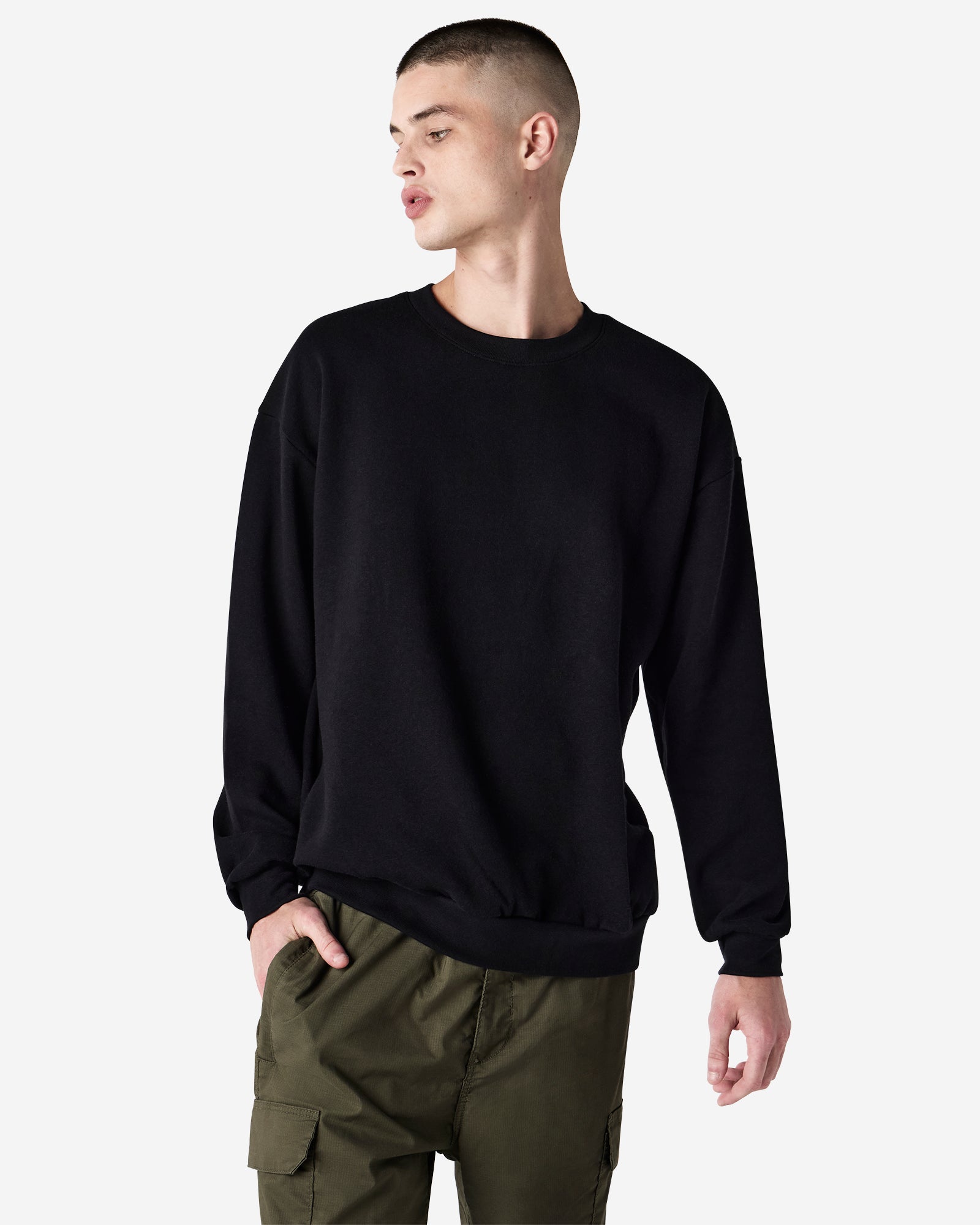Male model wearing a Reflex Unisex Crewneck Sweatshirt (front pose) -black