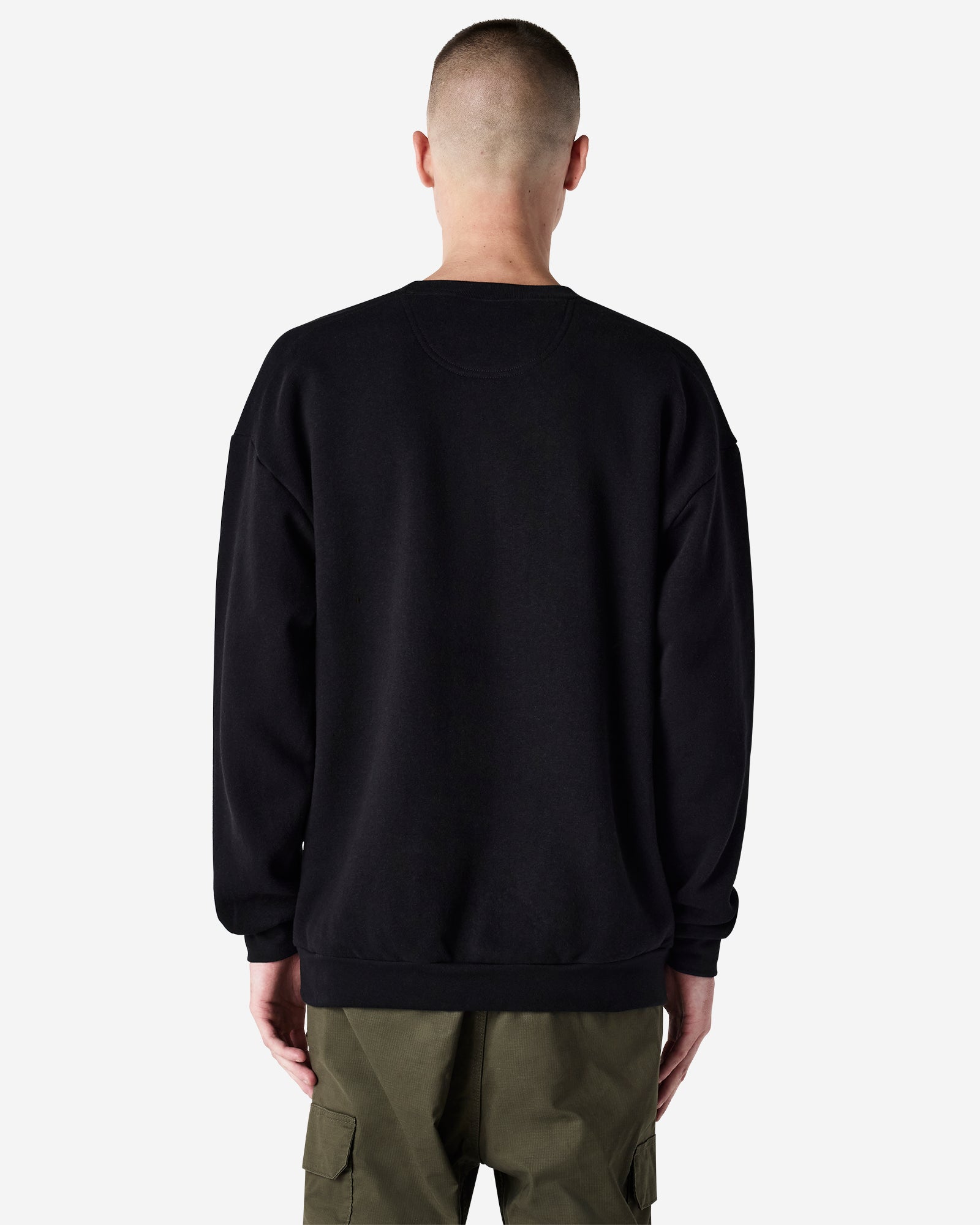 Male model wearing a Reflex Unisex Crewneck Sweatshirt (back pose) -black