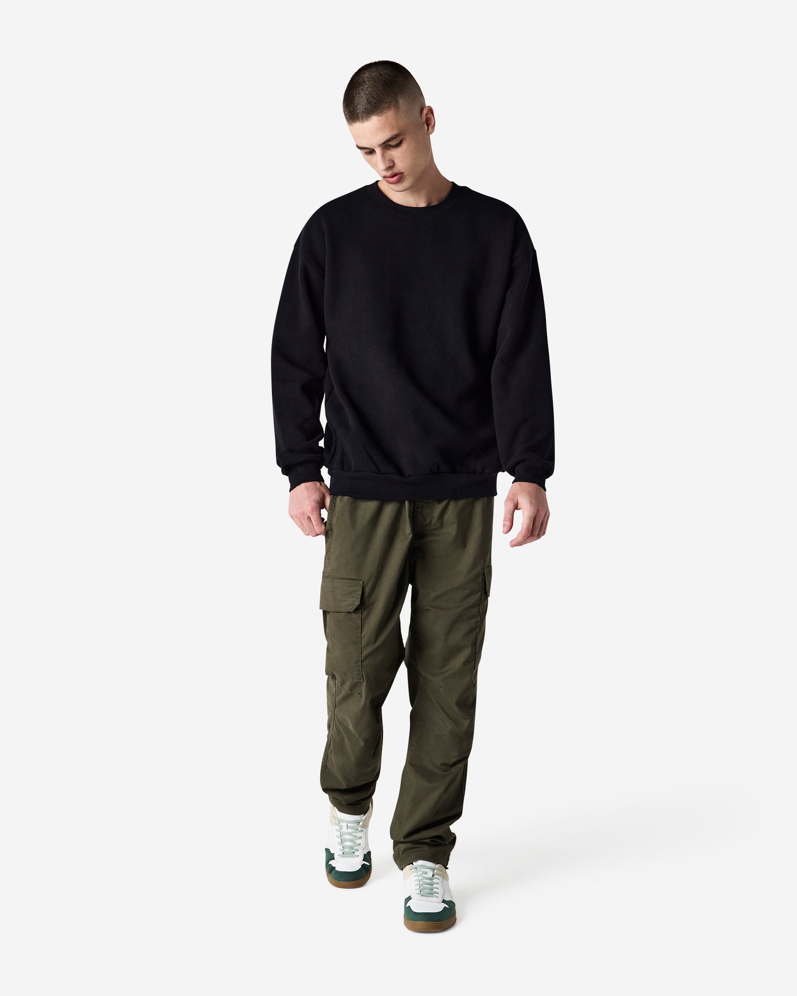 Male model wearing a Reflex Unisex Crewneck Sweatshirt (front pose) -black