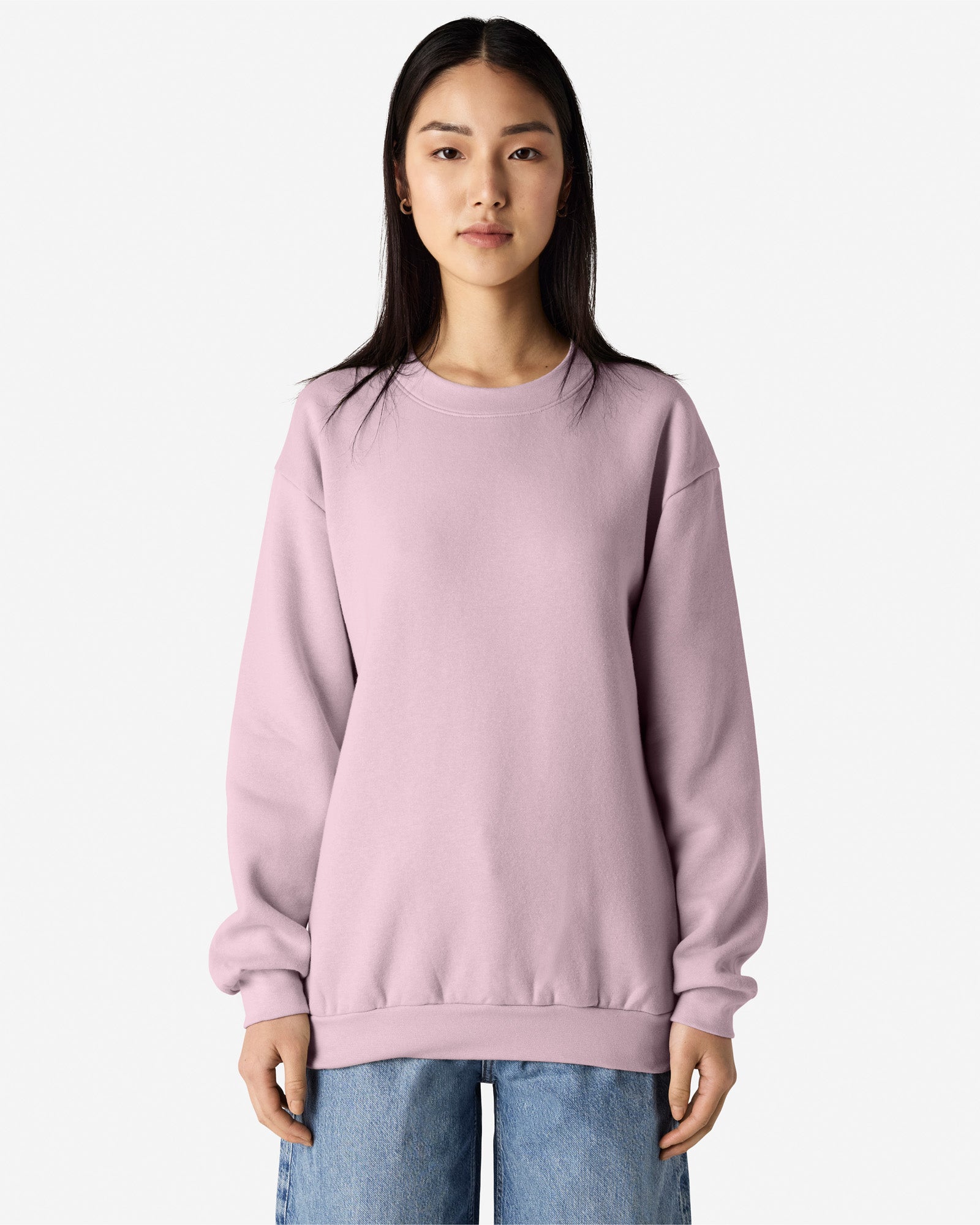 Female model wearing a Reflex Unisex Crewneck Sweatshirt (front pose) -blush