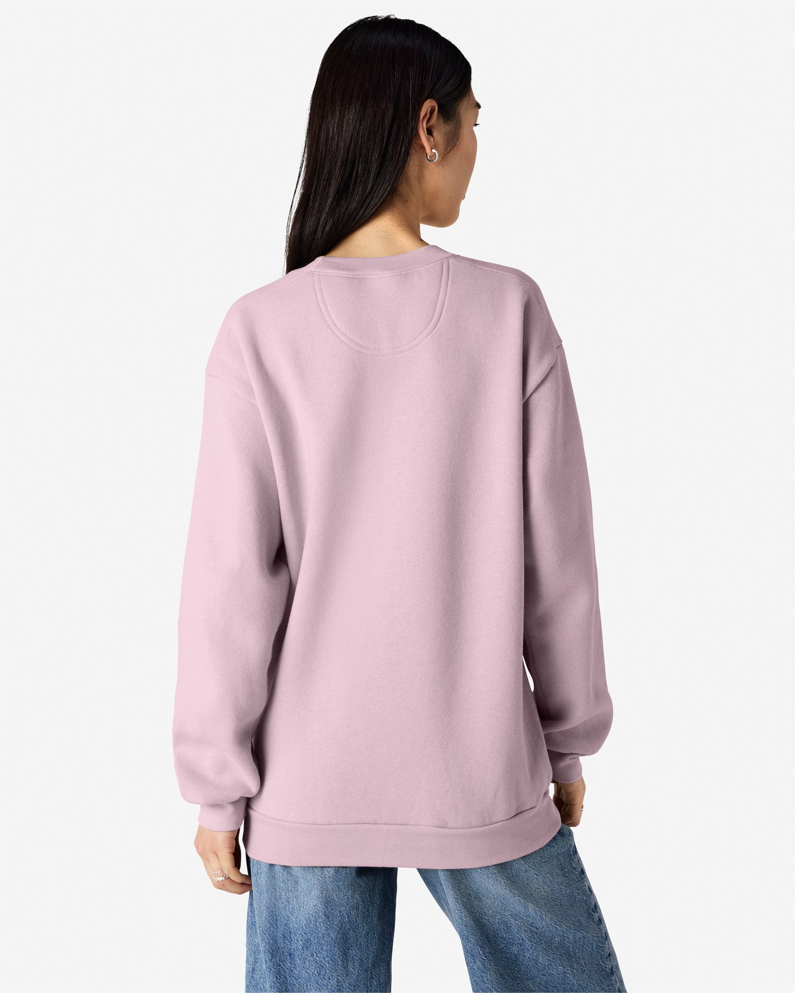 Female model wearing a Reflex Unisex Crewneck Sweatshirt (back pose) -blush