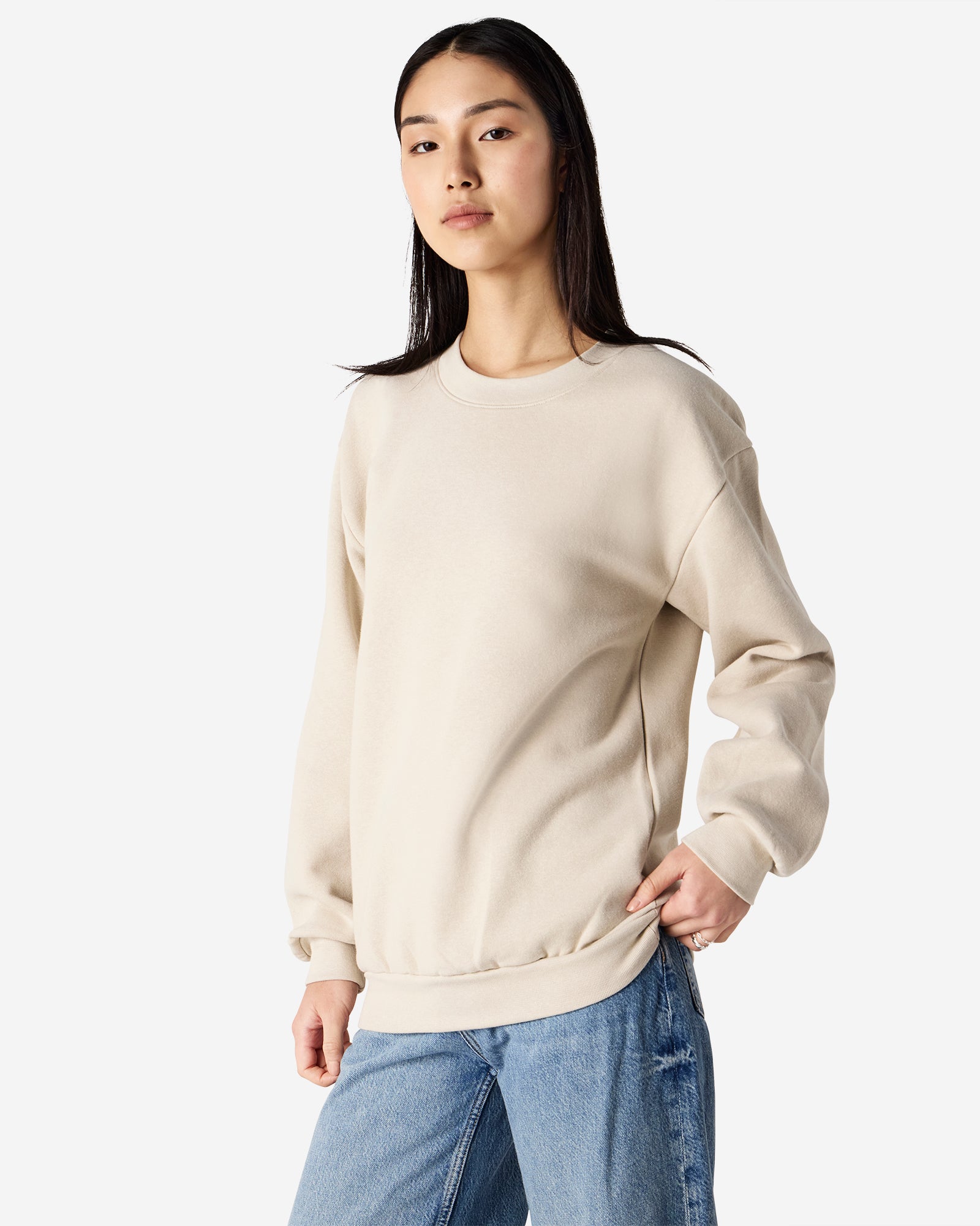 Female model wearing a Reflex Unisex Crewneck Sweatshirt (side pose) -bone