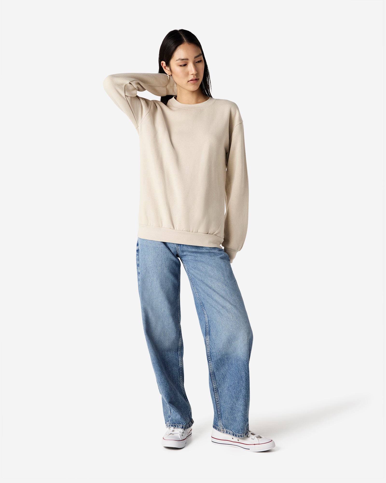 Female model wearing a Reflex Unisex Crewneck Sweatshirt (front pose) -bone
