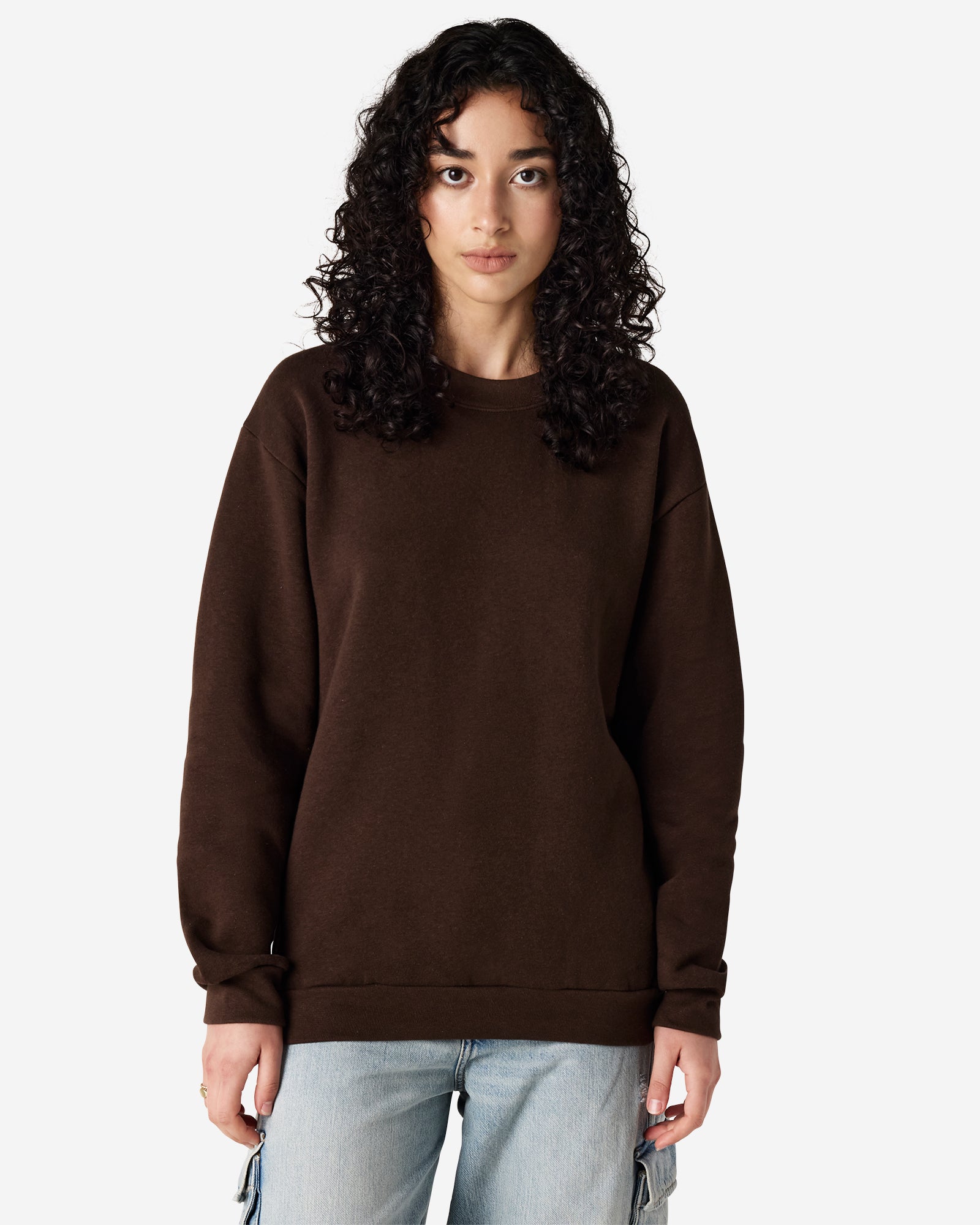 Female model wearing a Reflex Unisex Crewneck Sweatshirt (front pose) -brown