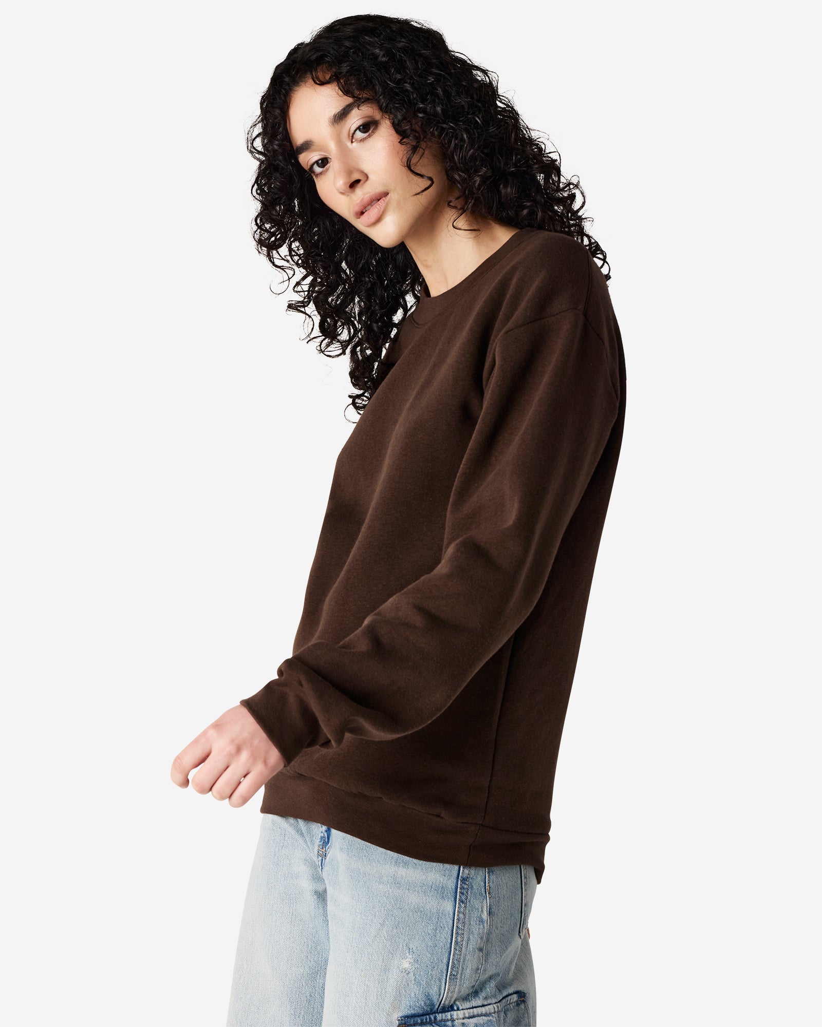 Female model wearing a Reflex Unisex Crewneck Sweatshirt (front pose) -brown