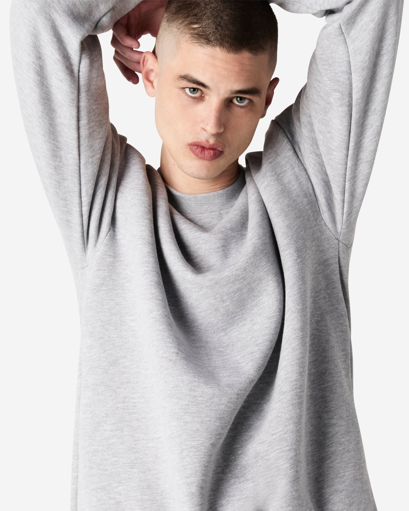 Male model wearing a Reflex Unisex Crewneck Sweatshirt (front pose) -heather grey