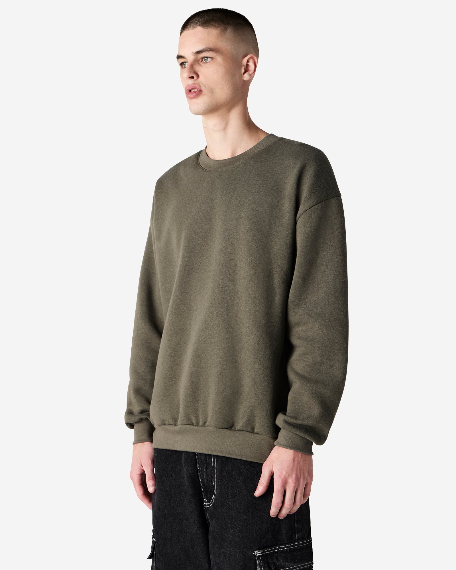 Male model wearing a Reflex Unisex Crewneck Sweatshirt (side pose) -lieutenant