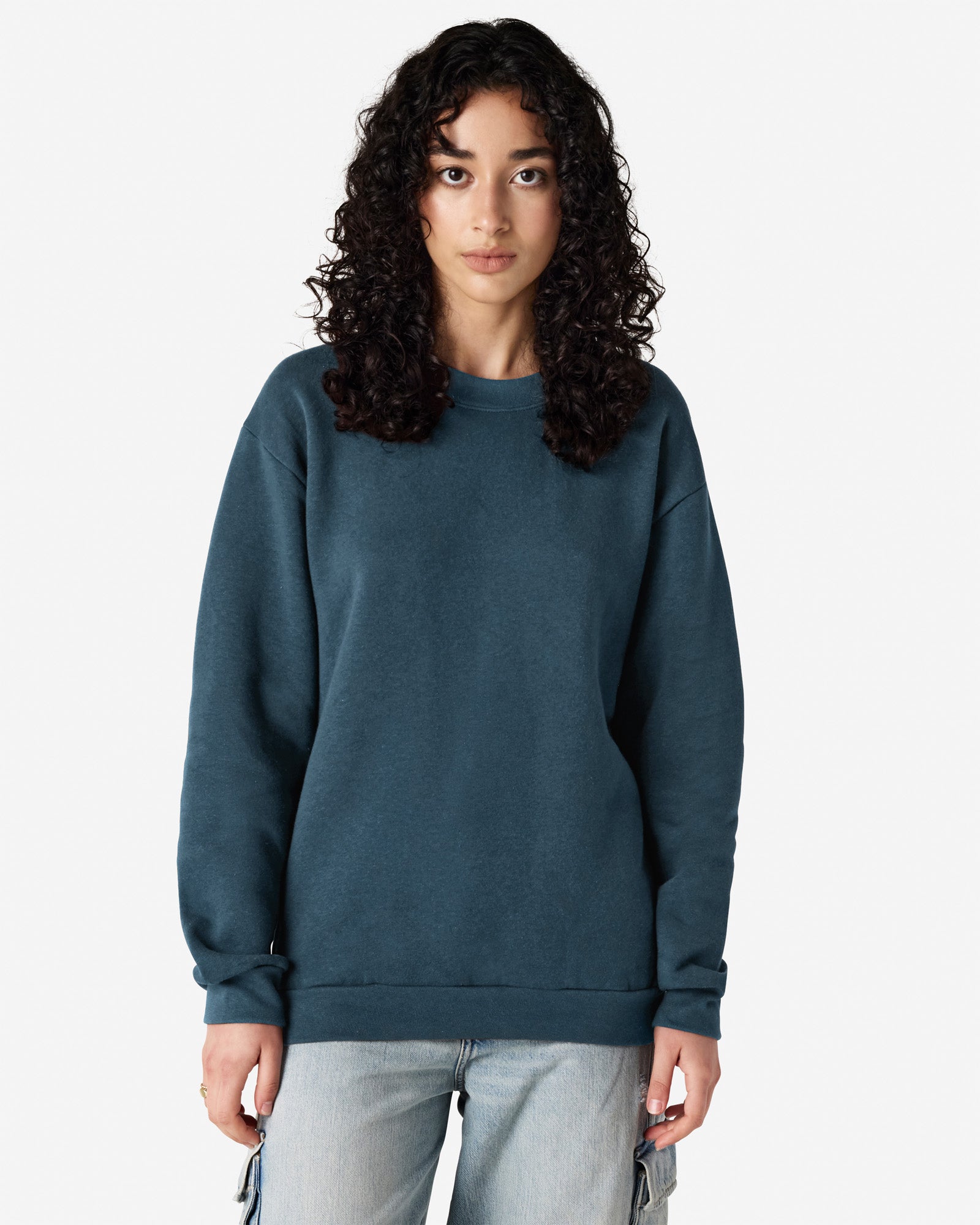 Female model wearing a Reflex Unisex Crewneck Sweatshirt (front pose) -sea blue