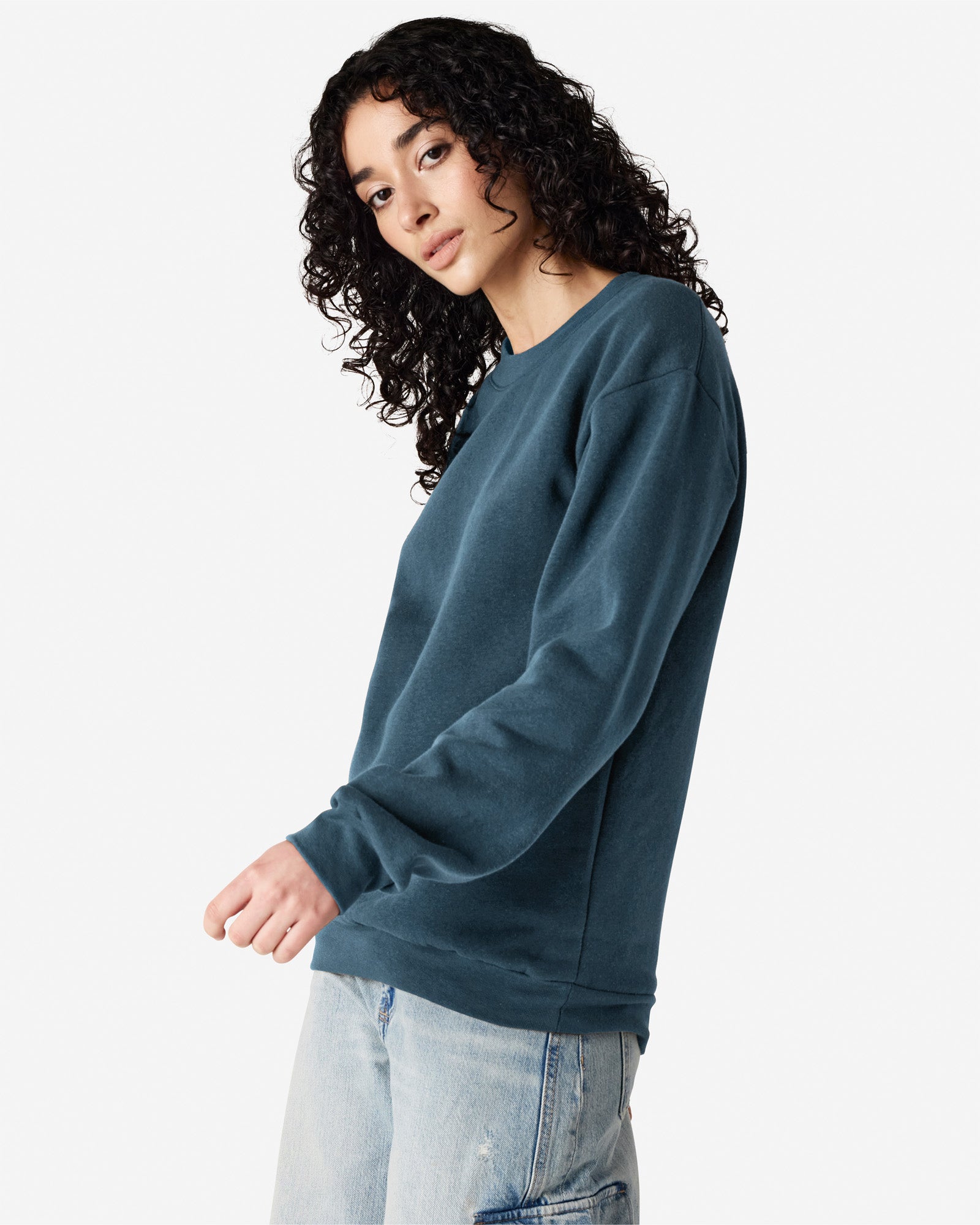Female model wearing a Reflex Unisex Crewneck Sweatshirt (front pose) -sea blue